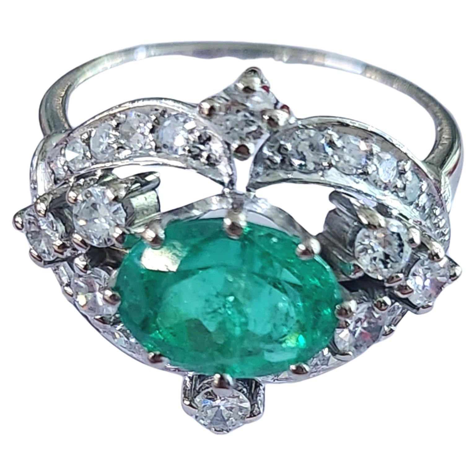 Vintage 18k white gold ring centered with natural green emerald estimate weight of 2 carats colombian green color flanked with brilliant cut diamonds H color white estimate weight 0.60 carats 