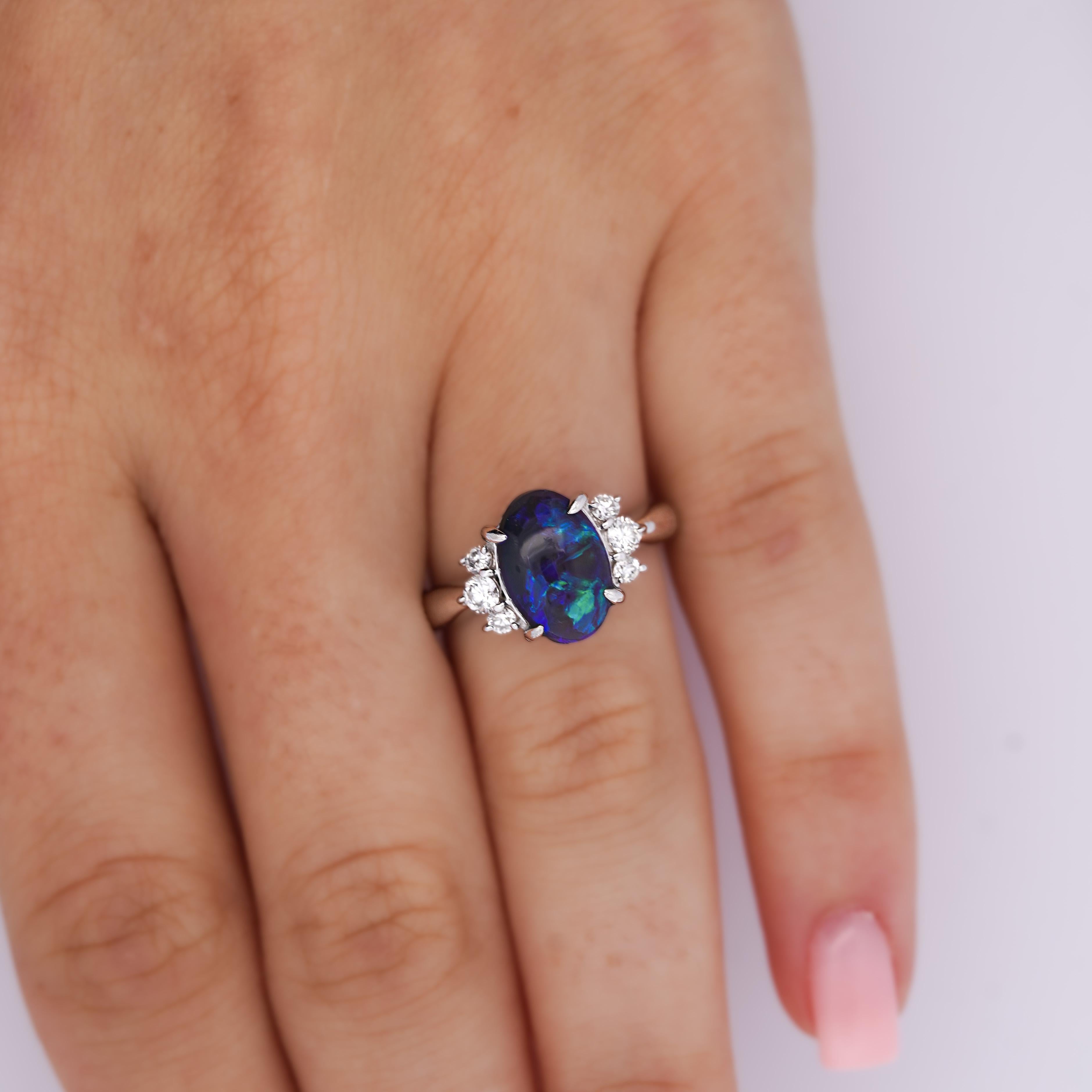 Vintage GIA certified black opal and diamond ring in platinum 900. The 2.17 carat opal bears an excellent display of color with very good luster and translucence. Unmistakably a natural opal that's not too facey and set in a sturdy tapered platinum