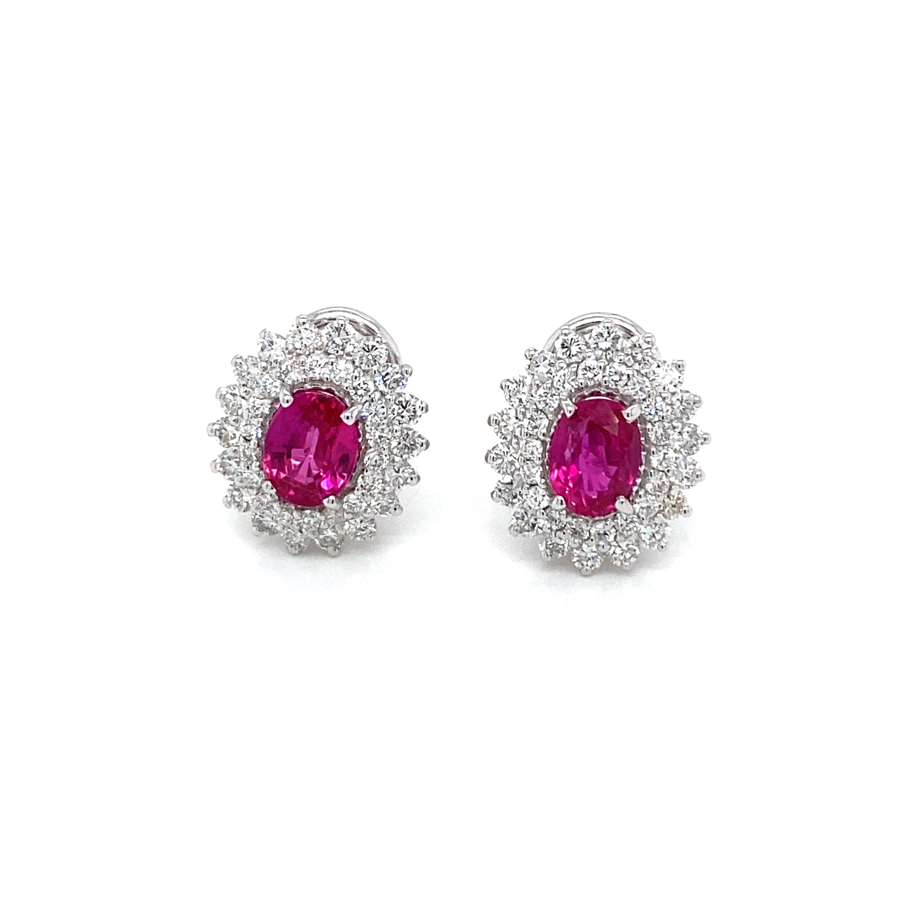 Gorgeous pair of vintage Natural Ruby diamond cluster earrings handcrafted in solid 18k white Gold. 

They are set with Bright Natural Ruby Oval cut in the center, total weight 2 carat, and surrounded by an halo of colorless sparkling Round