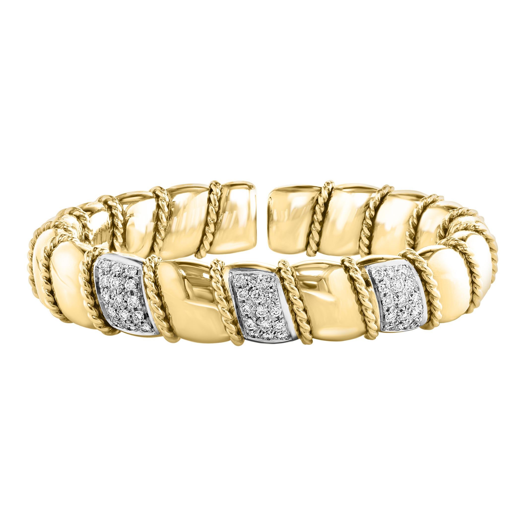 This exquisite vintage cuff bangle bracelet showcases two carats of dazzling diamonds set in an elegant 18 karat solid yellow gold. The bangle is designed with three bars adorned with round brilliant cut diamonds, creating a stunning visual appeal.