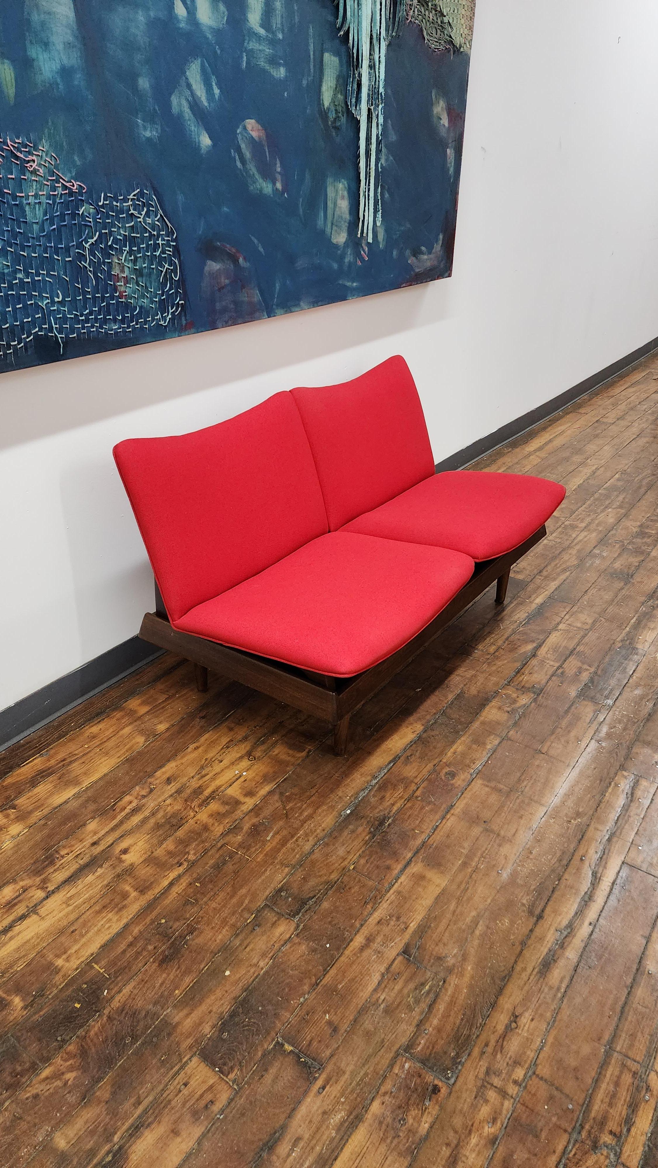 Beautiful modular 2 seat sofa by Gerald McCabe.  the set has been completely refinished and has new red maharam upholstery.  the modular seats can be removed and used as floor seats and the base can be used as a  coffee table.