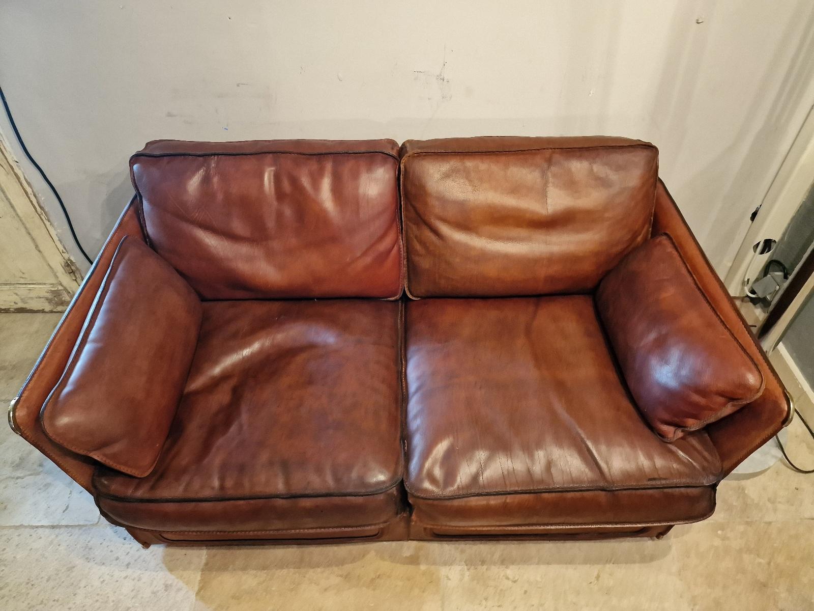 Vintage Roche Bobois 2-seater sofa in thick buffalo leather and goose feather, brass corners.  Circa 1970.
Also available as a pair.  In very good shape.
Price per sofa
 (3-seater sofas and armchair model also available.)
