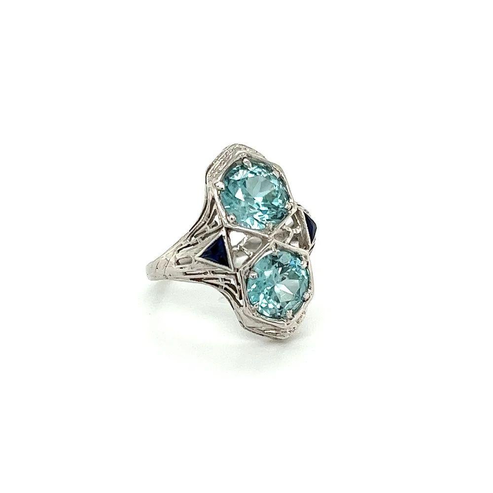 Simply Beautiful! Finely detailed Vintage Art Deco 2-Stone Blue Zircon Gold Cocktail Ring. Centering two securely nestled Blue Zircon, weighing approx. 5.00tcw, accented by synthetic Sapphires. Hand crafted 18K White Gold mounting. Ring size 5.5, we