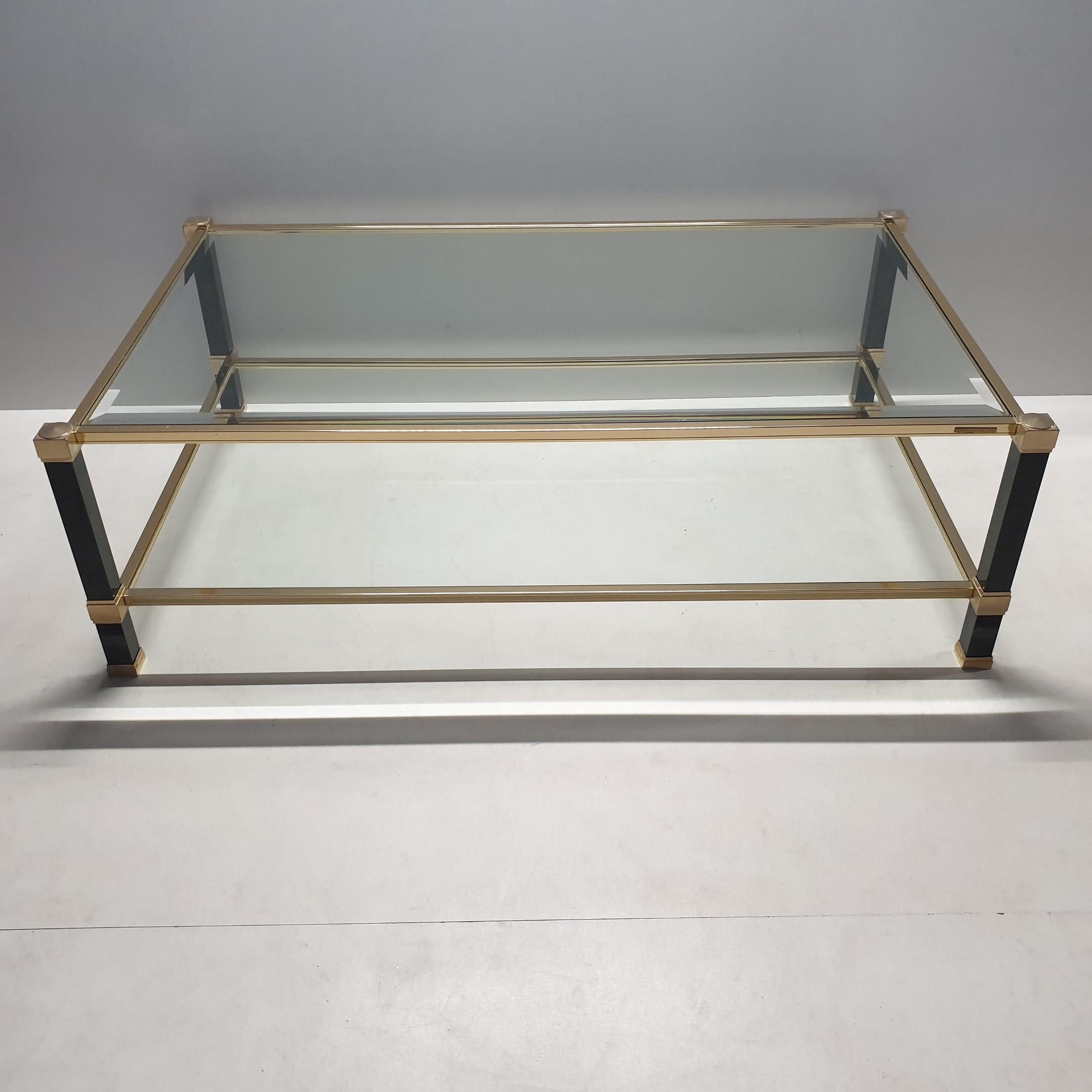 Vintage 2-tiers brass coffee table by Pierre Vandel, 1980s
With a two tone brass frame and faceted glass.