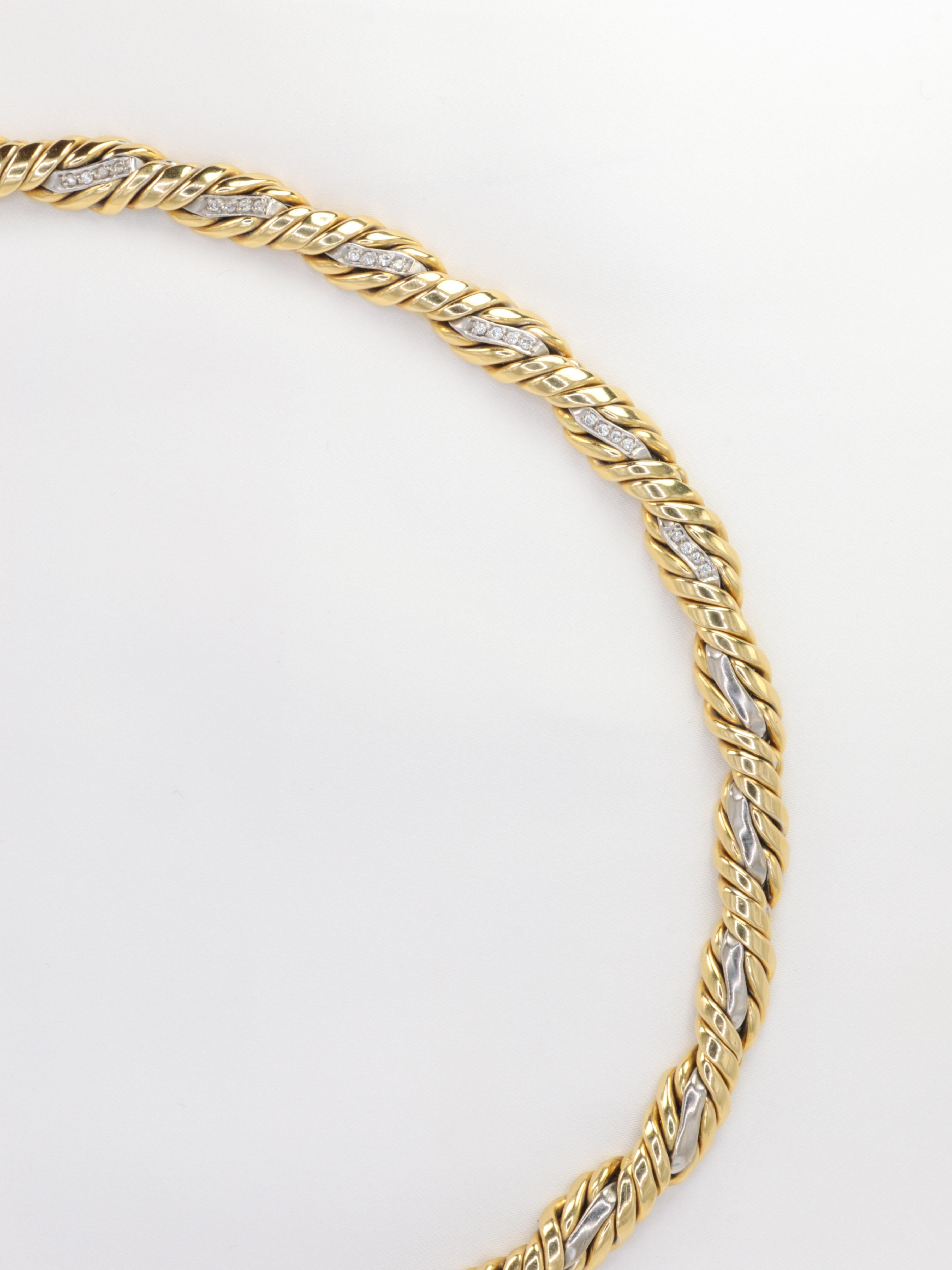18Kt (750°/°°) yellow and white gold rope necklace formed of braided gold wires. In the center of the necklace, the white gold part is set with small 8x8 diamonds.
This necklace was purchased from Bucherer in Lugano in the 1980's. There is a trace