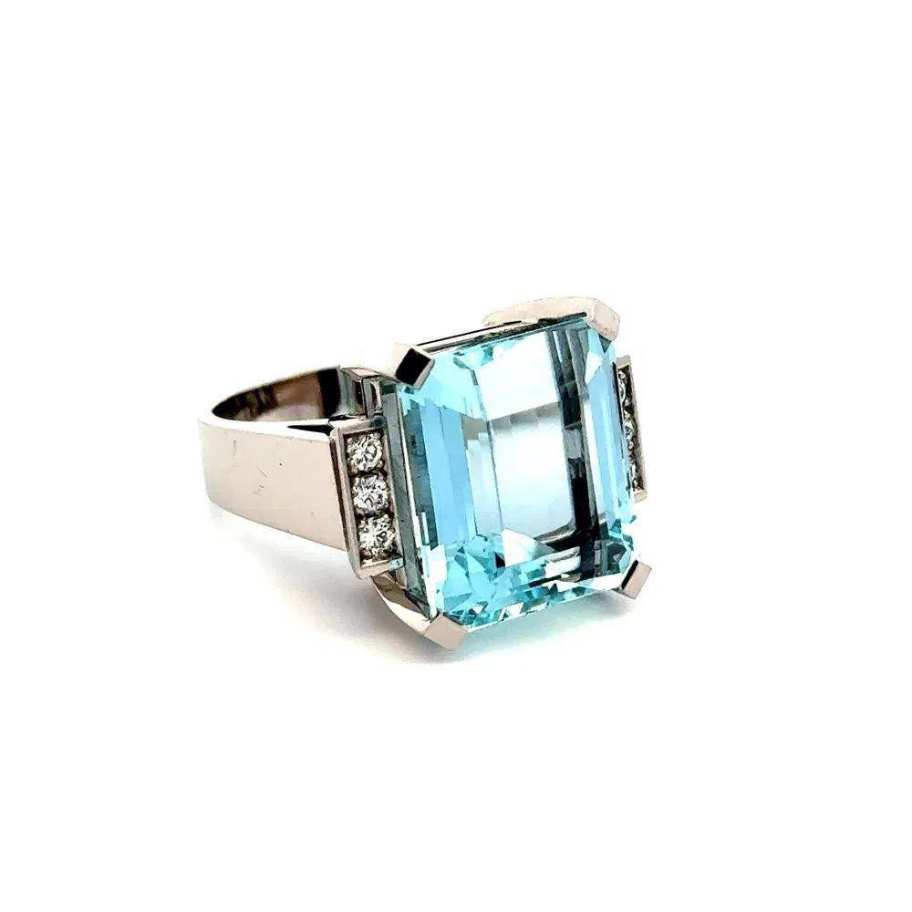 Simply Beautiful! Aquamarine and Diamond Gold Retro Ring. Centering a securely Hand set a Emerald Cut Aquamarine, weighing approx. 20 Carat. Both sides of ring Hand set with Round Brilliant Cut Diamonds, approx. 0.30tcw. Hand crafted 18K White Gold