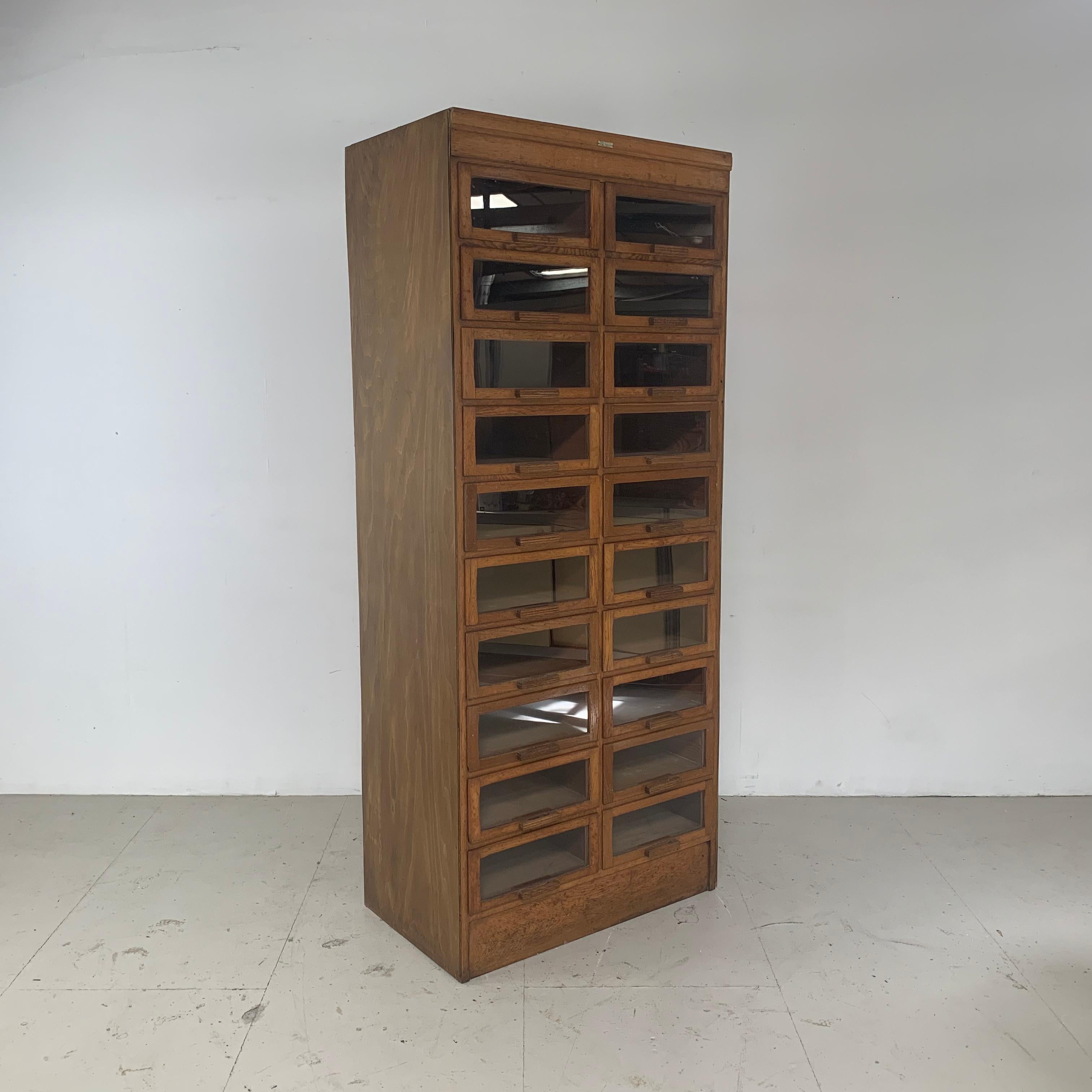 Really lovely vintage 20-drawer haberdashery shop cabinet from the 1940s-1950s with wooden handles. Made by Dudley & Co.

In good vintage condition. Some scuffs here and there, commensurate with age. It has been fully restored but please bear in
