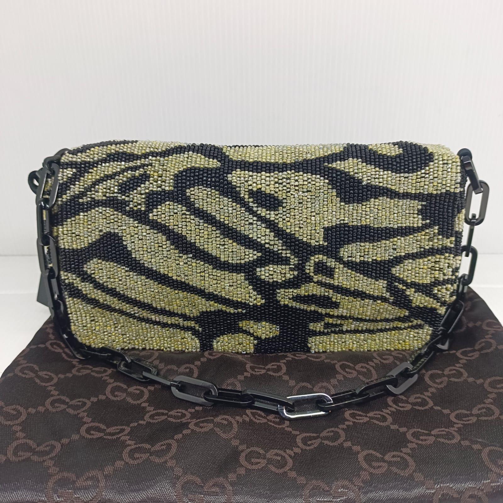 Iconic gucci by Tom Ford collection. Zebra beaded evening bag with black chain. Slight yellowing on the beads but still blends in well with the bag. Silk lining. Comes with dust bag.