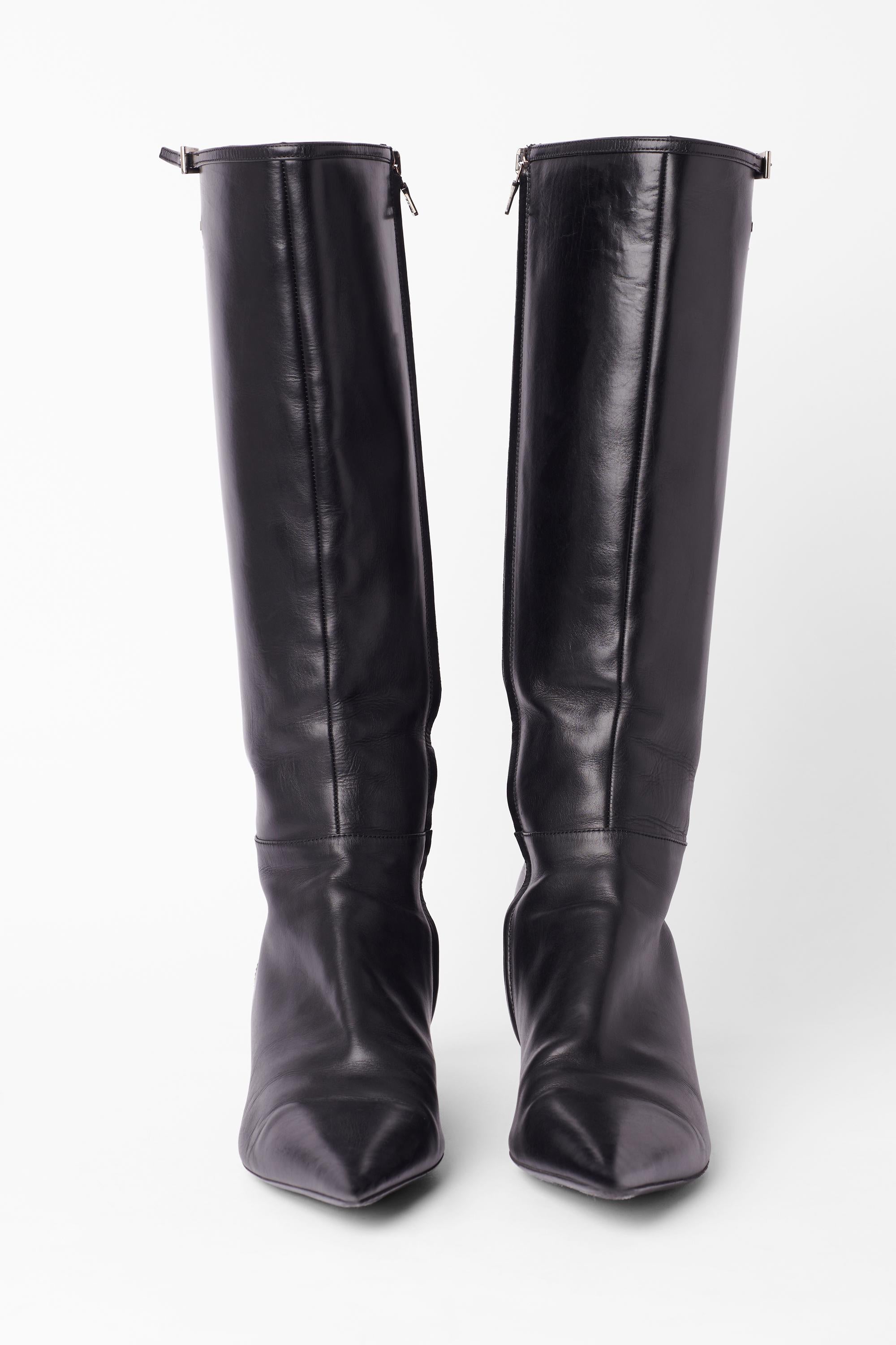 Vintage circa 2000's schwarzes Leder spitzen Zehen Stiefel von Prada. Sie haben einen Kitten-Heels-Stil, dünnes Leder und eine silberne Schnalle auf der Oberseite, das silberne Prada-Logo ist auf jedem Schuh eingraviert. Wird mit einem schwarzen