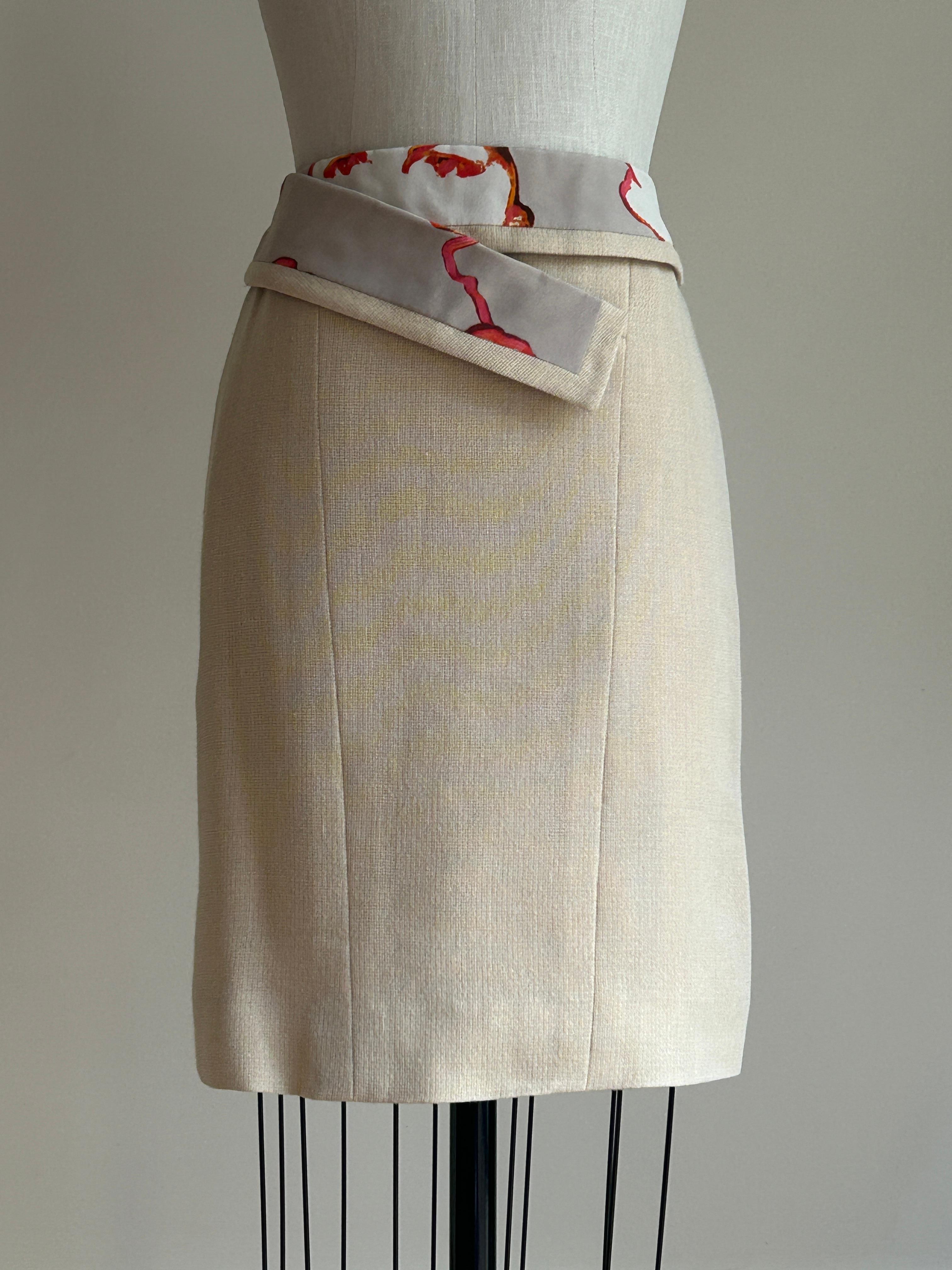 Vintage 2000s Chanel pencil skirt in a textured beige weave. Trimmed in a fun abstract print featuring the face of the iconic Coco Chanel in bright pink. (The print on this one has fallen perfectly so that it looks like Coco is playing peekaboo over