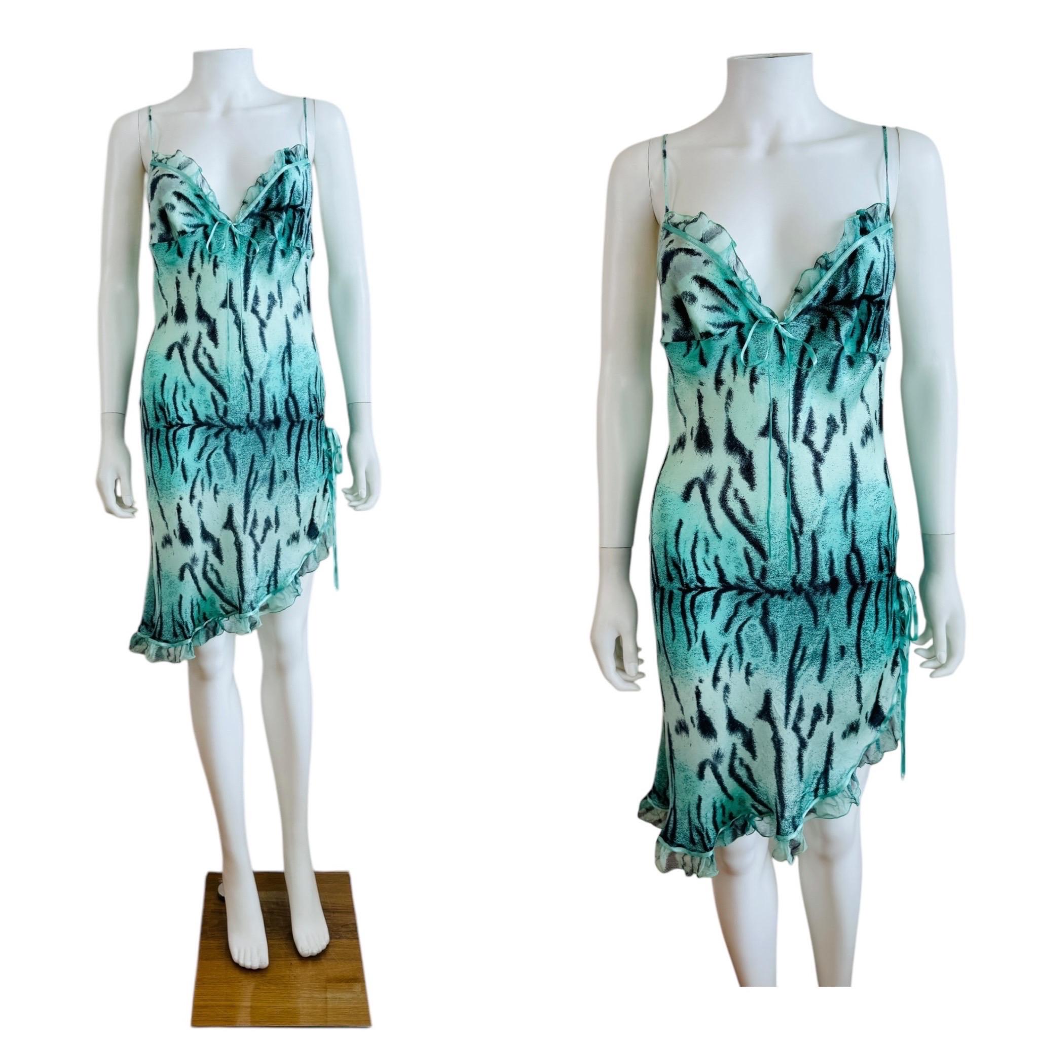 Vintage 2000s Roberto Cavalli dress
Turquoise blue tiger print tissue silk fabric
V neckline with fitted bust details + ruffle trim
Mini length with raised hem at the left hip with bow detail
Ruffle hemline
Unlined
Slips on overhead

Size 44,
