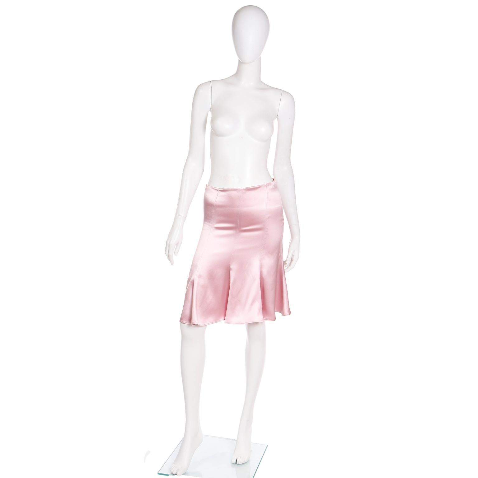 This early 2000's Valentino pink luxe silk skirt sits on the low waist and the godet style gives it so much movement! There is an invisible zipper on the side seam with a hook and eye. for closure. Made in Italy.

Fits size XS.
WAIST: (low)