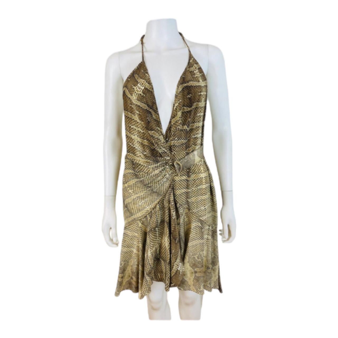 Vintage 2000s Y2K Roberto Cavalli Dress
Snake print silk fabric
Halter neckline
Deep V neckline
Wrap style dress with gold metal closure at the left hip
Mini length skirt with ruffled hem
Ruffle detail on the upper back
Unlined

Marked 42,