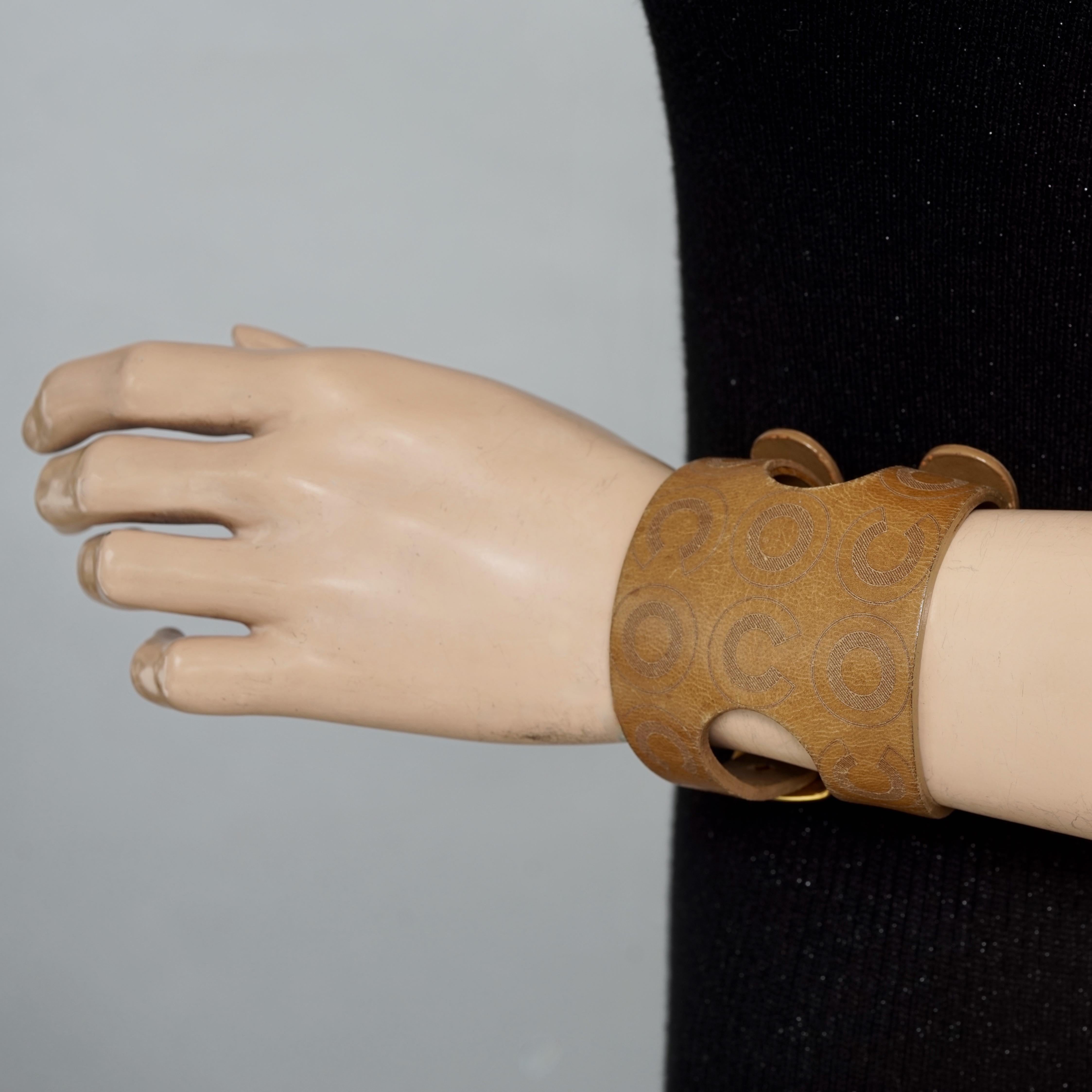 Vintage 2001 COCO CHANEL Double Buckle Brown Leather Cuff Bracelet

Measurements:
Height: 2.55 inches (6.5 cm)
Inside Circumference: 6.30 inches until 8.07 cm (16 cm until 20.5 cm) 

Features:
- 100% Authentic CHANEL.
- Wide brown leather with