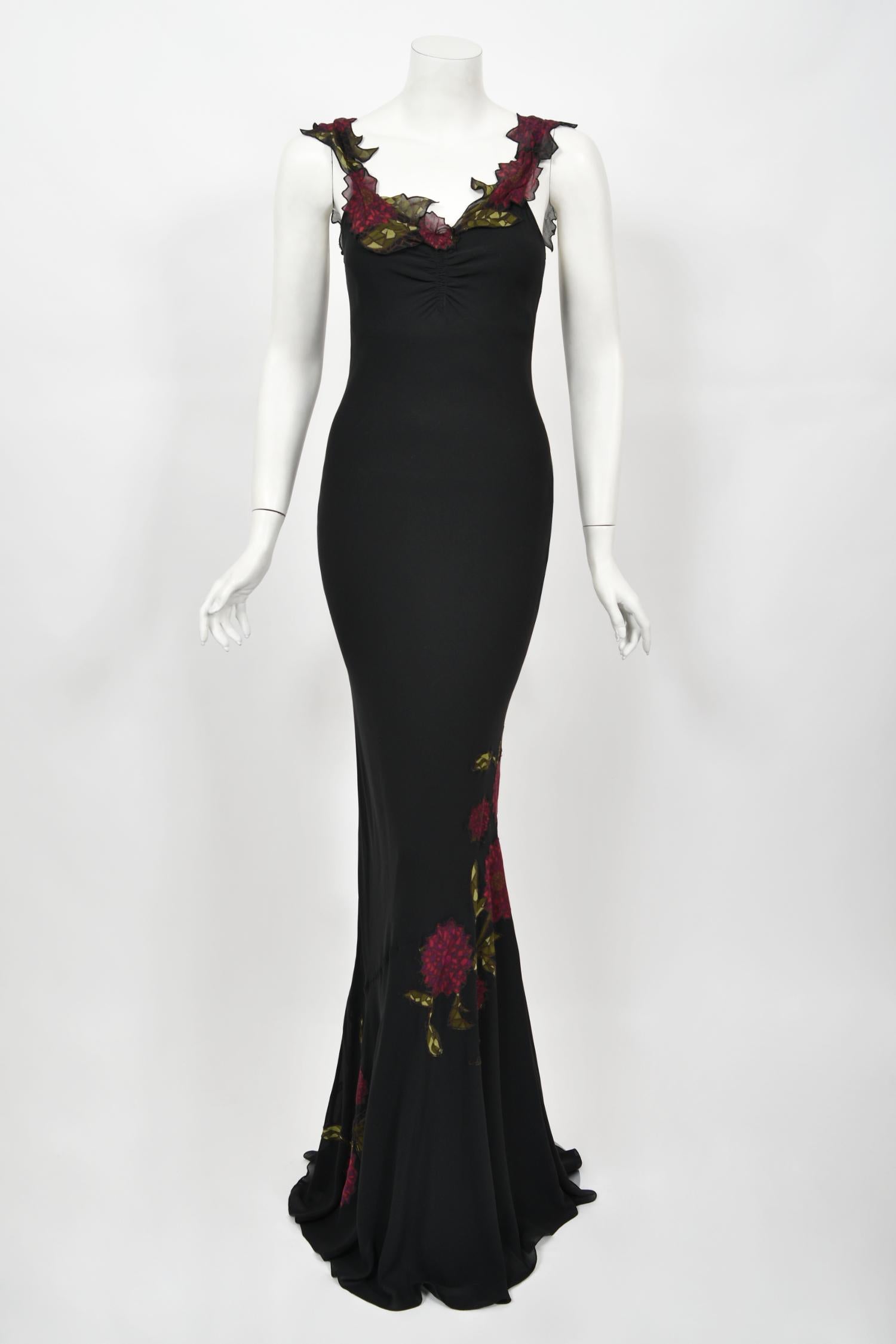 A truly sensational and highly coveted John Galliano red floral appliquéd black silk chiffon bias-cut slip gown dating back to his fall-winter 2001 collection. These early examples of his work are very collectable and are becoming incredibly hard to