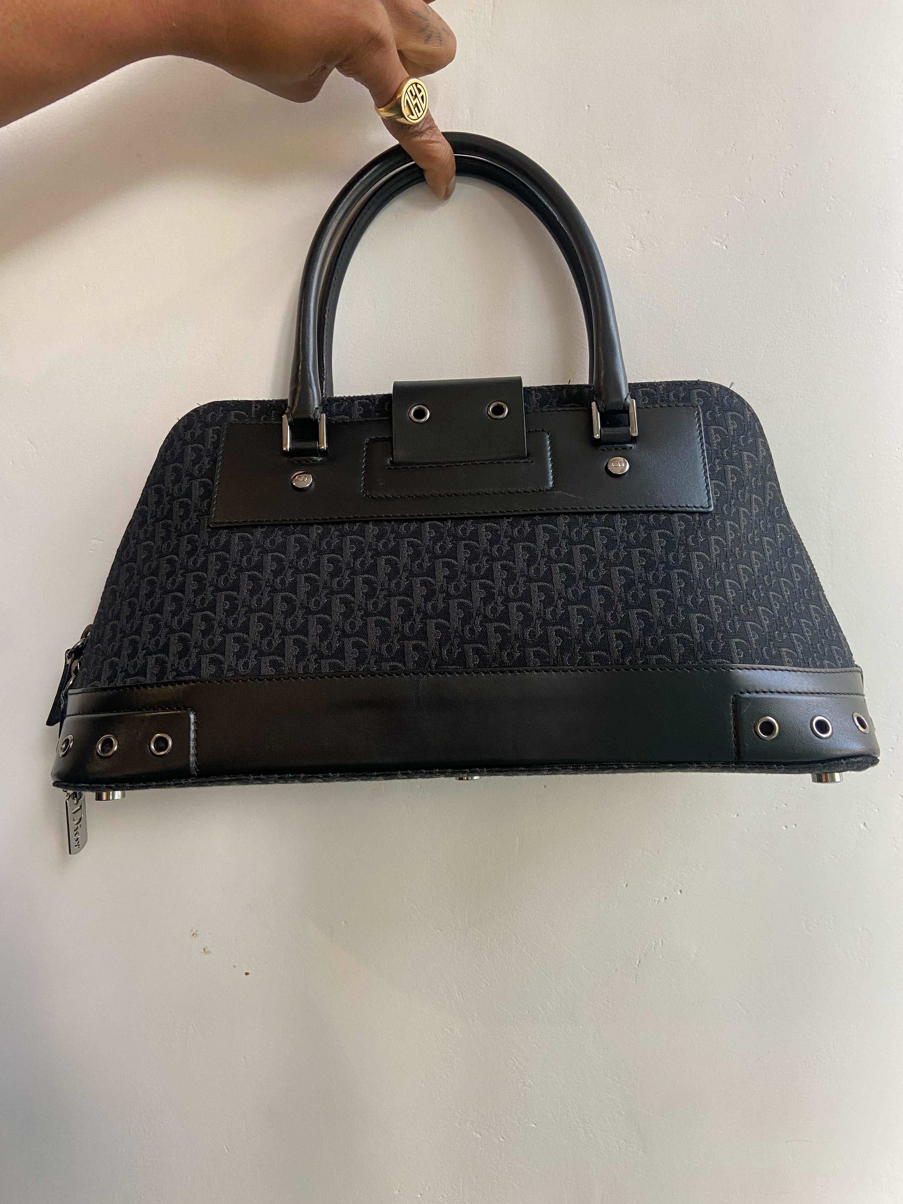 Christian Dior by John Galliano 2002 top handle black monogram trotter bag. Feature Dior hardware, structured shape, canvas body, canvas body, cowhide leather features, inside zip back pocket, rolled leather top handles. In great vintage condition.
