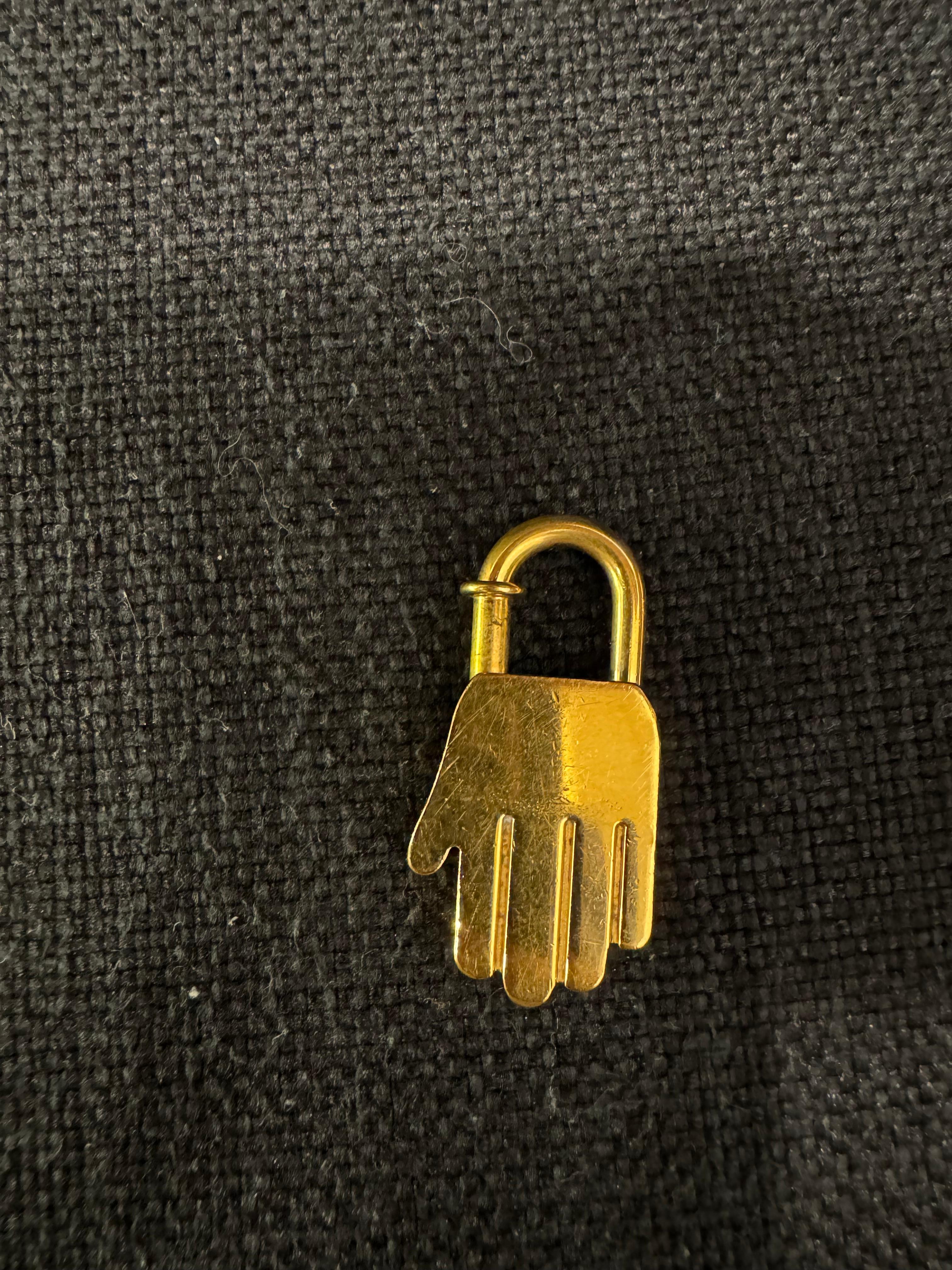 Beautiful vintage charm for bags or can be worn as pendant as well. Beautiful yellow gold color. Perfect way to accessorize your bag. Slight scratches and scuffing to the item. Comes with its original dust bag.