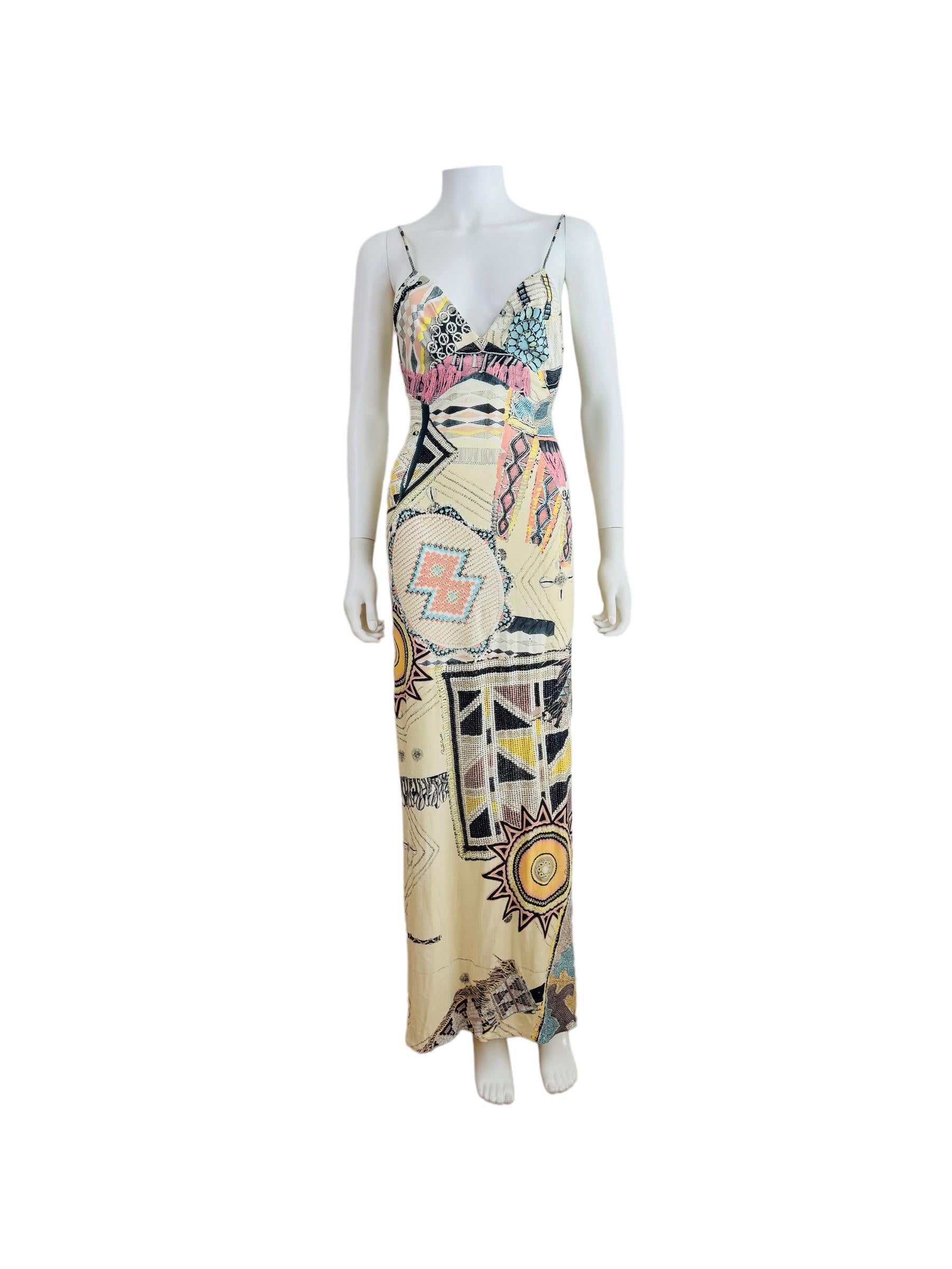 Beautiful 2003 Roberto Cavalli Dress
Cream elastic material with oversized tribal, turquoise jewelry + seashell print throughout with silver glitter style painted accents
Fitted bust with V neckline
Thin shoulder straps that have been shortened