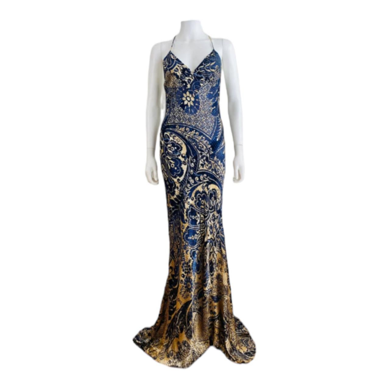 Stunning 2005 Roberto Cavalli Dress
Navy blue + tan print on silk
Thin shoulder strap that cross on the upper back
Fitted bust with V neckline
Thin shoulder straps
Fitted dress throughout with mermaid flared hem
Train in the back
Maxi