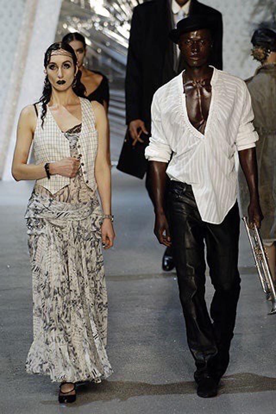 A breathtaking John Galliano novelty newspaper print semi-sheer silk chiffon bias cut gown dating back to his documented 2006 spring-summer Paris runway collection. Vogue commented on this memorable show, 