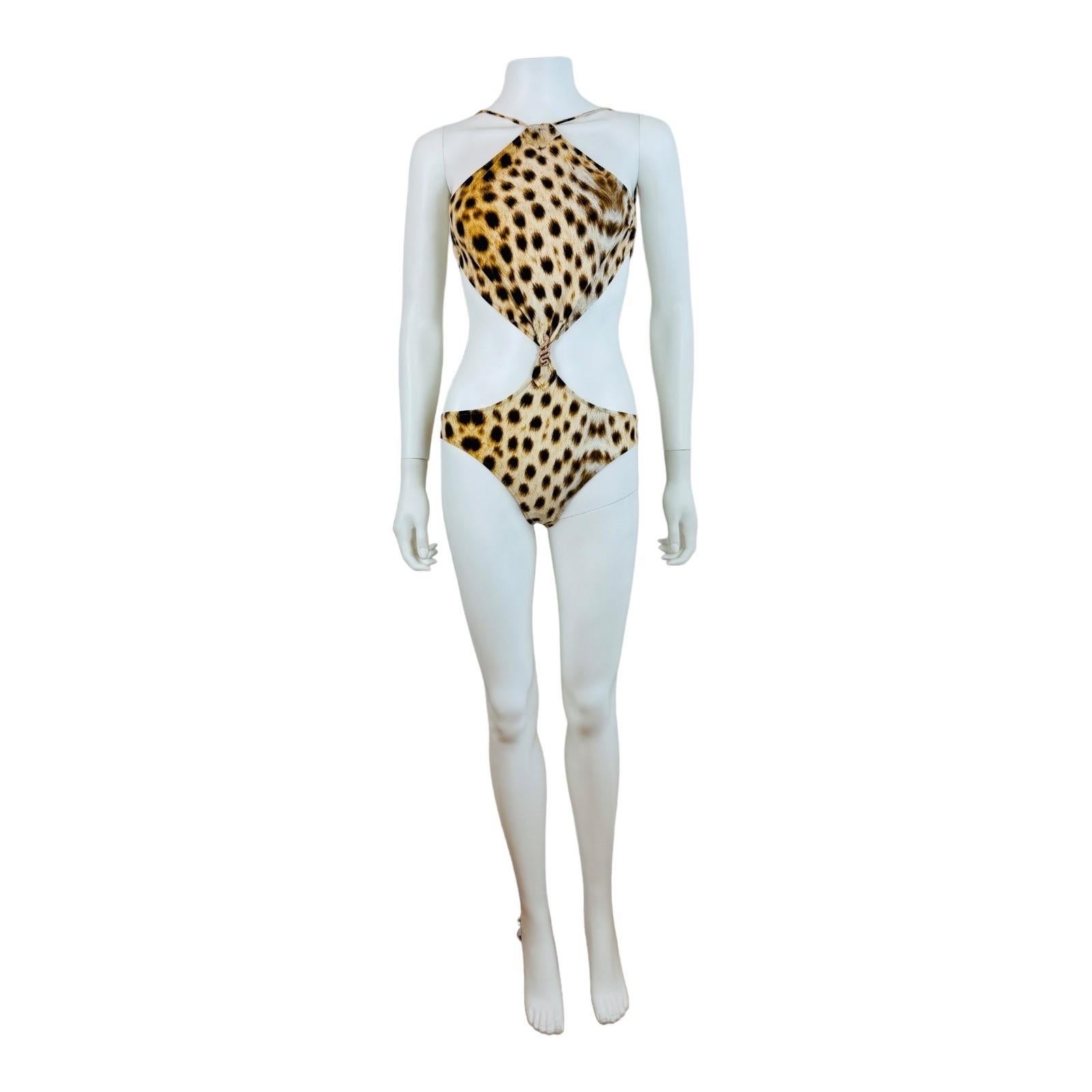 Vintage 2007 Roberto Cavalli Bathing Suit
Stretch fabric with cheetah print
Halter neckline with think ties
Cut out style with open sides
Rose gold snake medallion on the front
Bikini style bottom
Open back with ties at the bra line
Full coverage