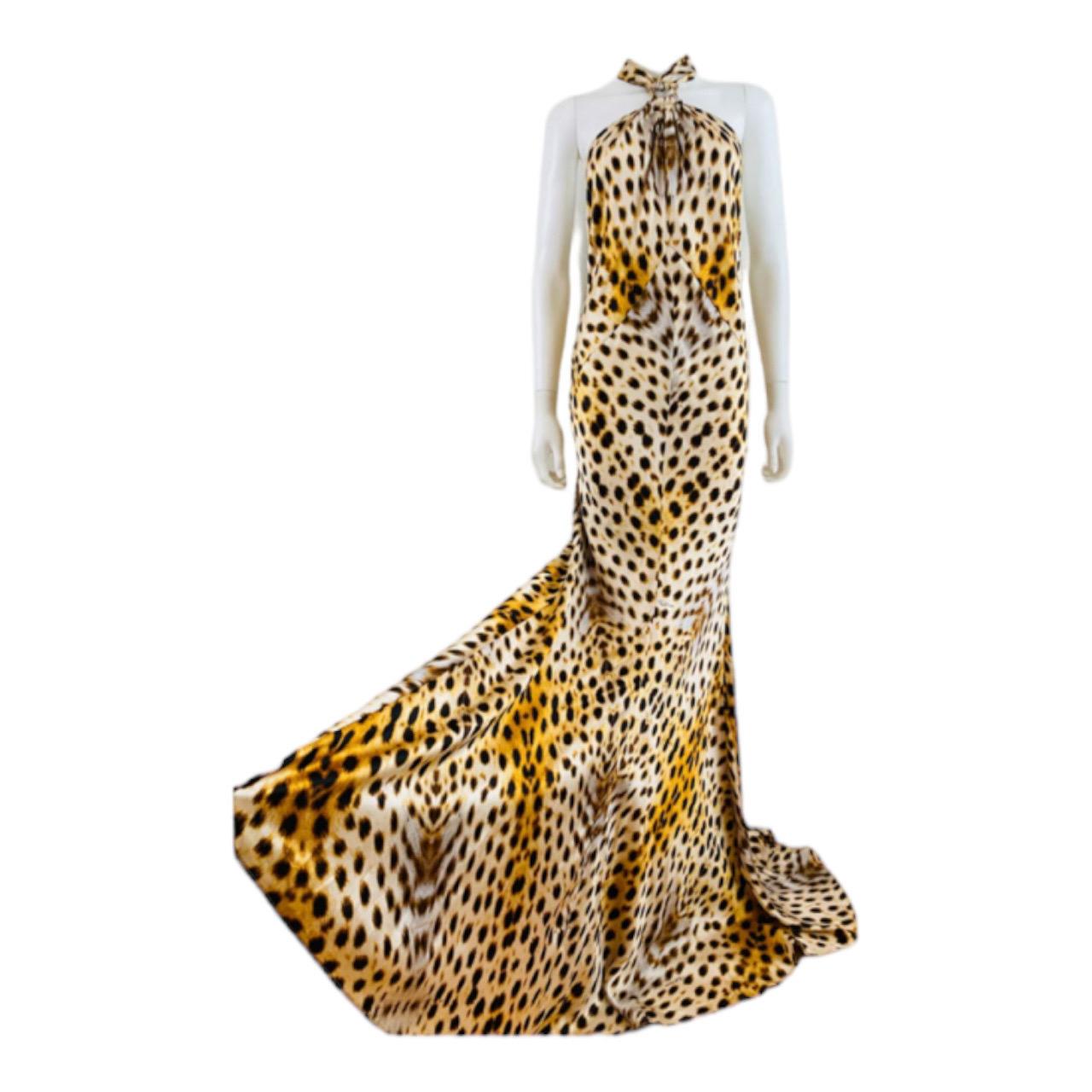 2007 Roberto Cavalli Silk Dress Gown
Incredible cheetah print silk fabric
Halter neckline with with long wide ties
High neckline with hammered gold metal detail at the neck
Form fitted style with wide flared mermaid hem
Open upper back
Hidden zipper