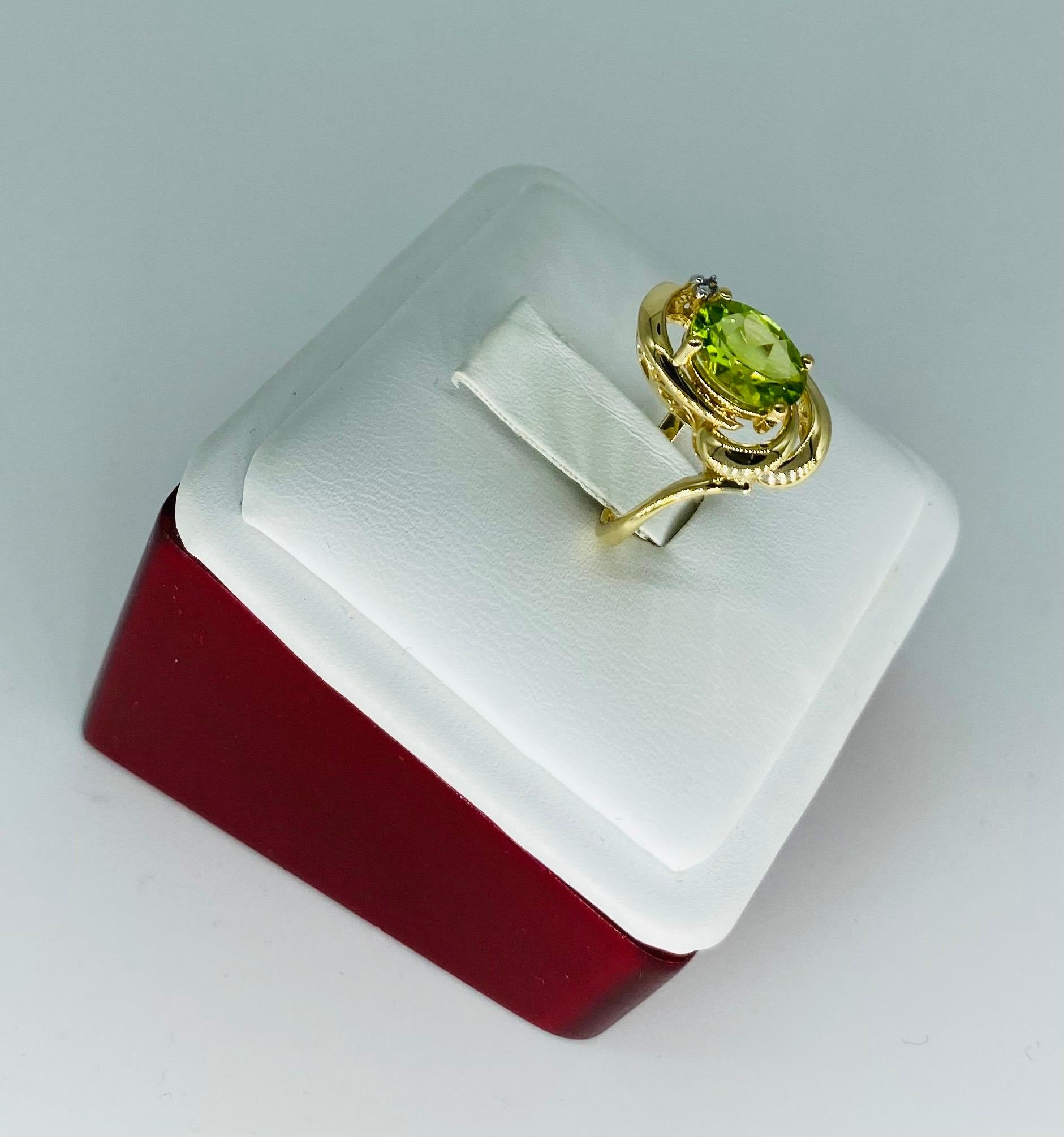 Vintage 2.02 Carat Peridot & Diamond Leaf Fashion Ring 14k Gold. Creative design with a center peridot weighing approx 2 carats and a single diamond on top connecting as a leaf design. Very nice design ring made in 14k solid gold. The ring is a size