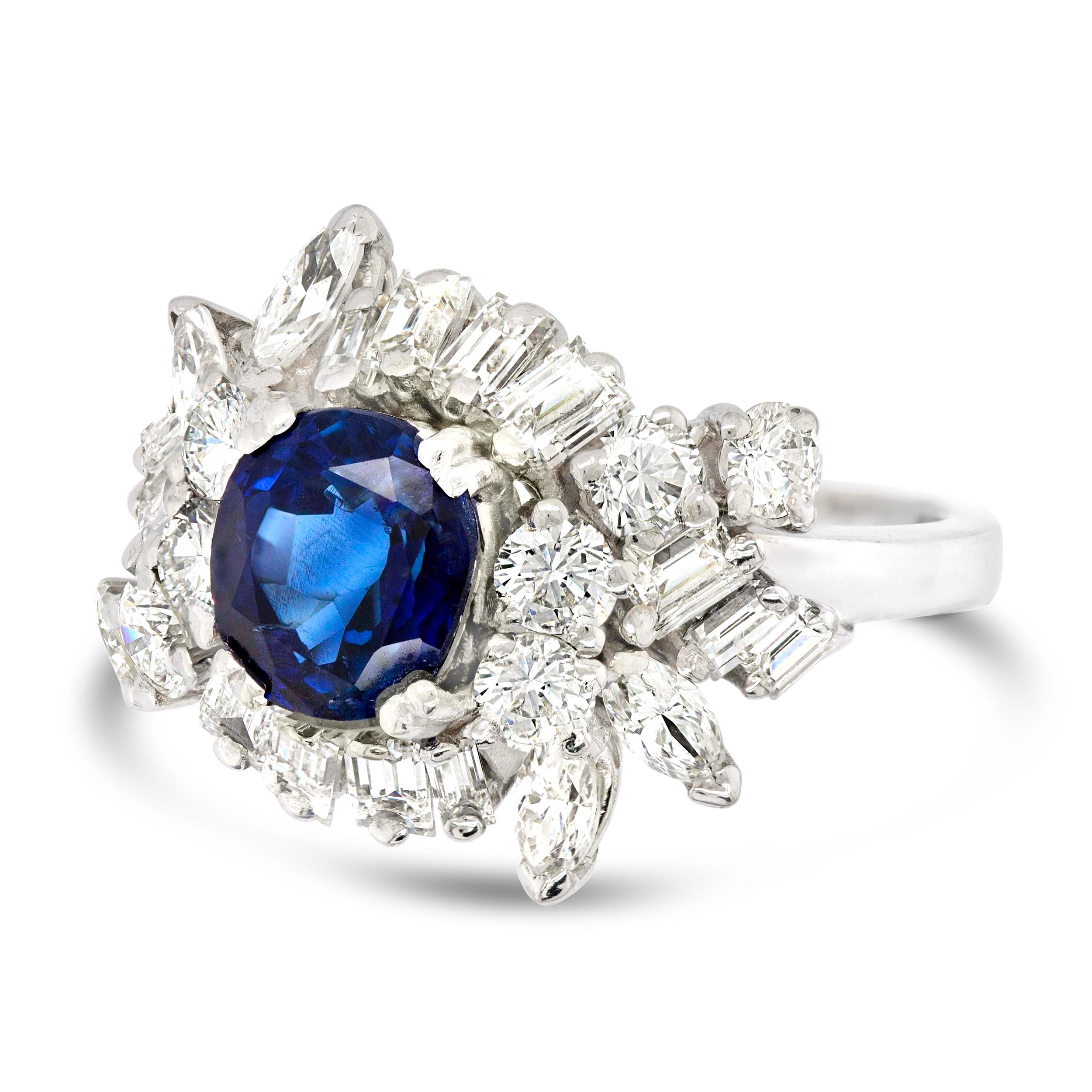 This glamorous Mid-Century cocktail ring is a vintage classic. At the center is a 2.02 carat oval Burmese sapphire with a rich blue hue that’s certified as natural and untreated making the already exceptional stunner a true gem. It’s accented by a