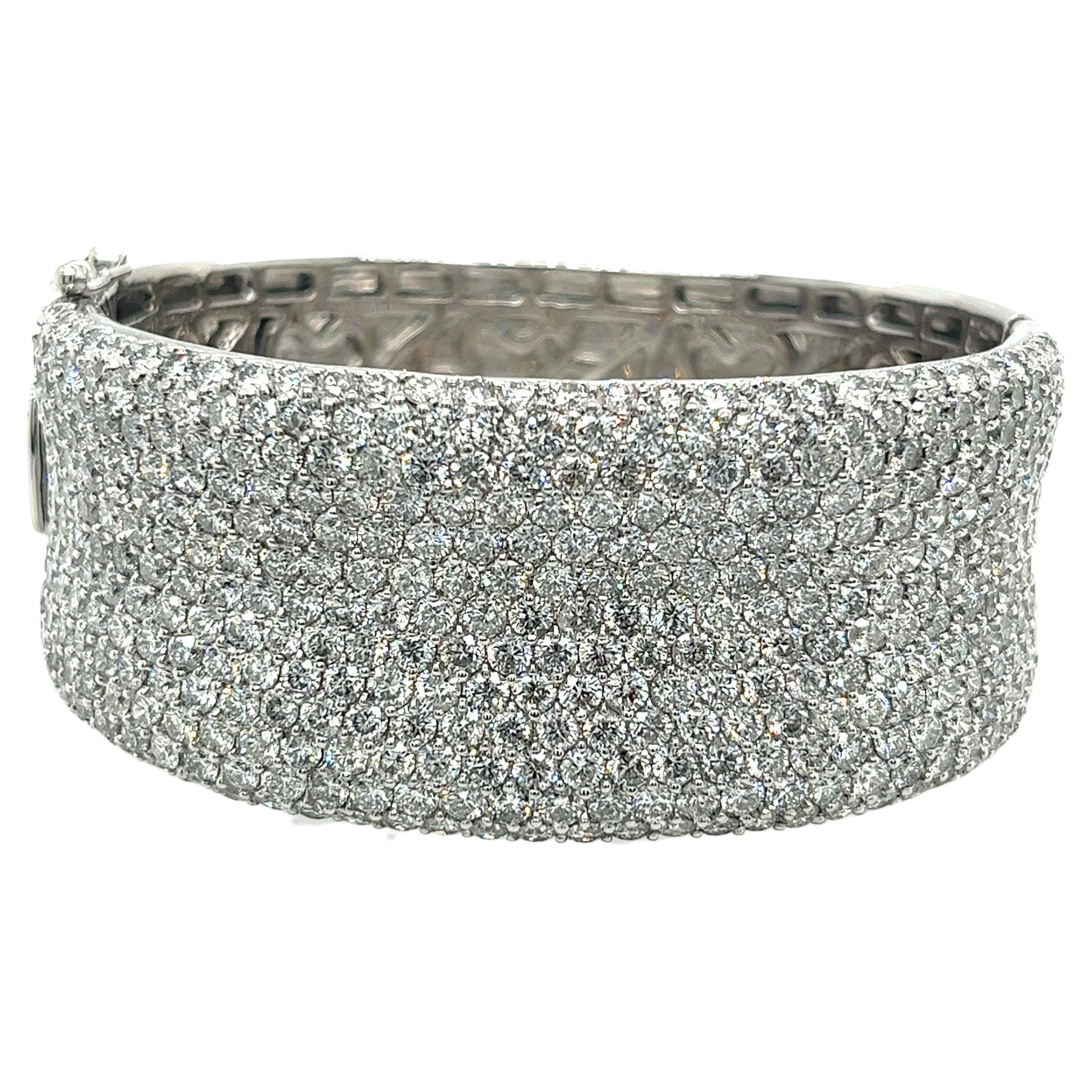 Indulge in luxury with this breathtaking 14K white gold diamond bangle, featuring a staggering 372 round diamonds totaling 20.40ctw, with F-G color and VS2-SI1 clarity. Weighing 77.8g and measuring 26.3mm in width, 2.2 inches in diameter, and 4.5mm