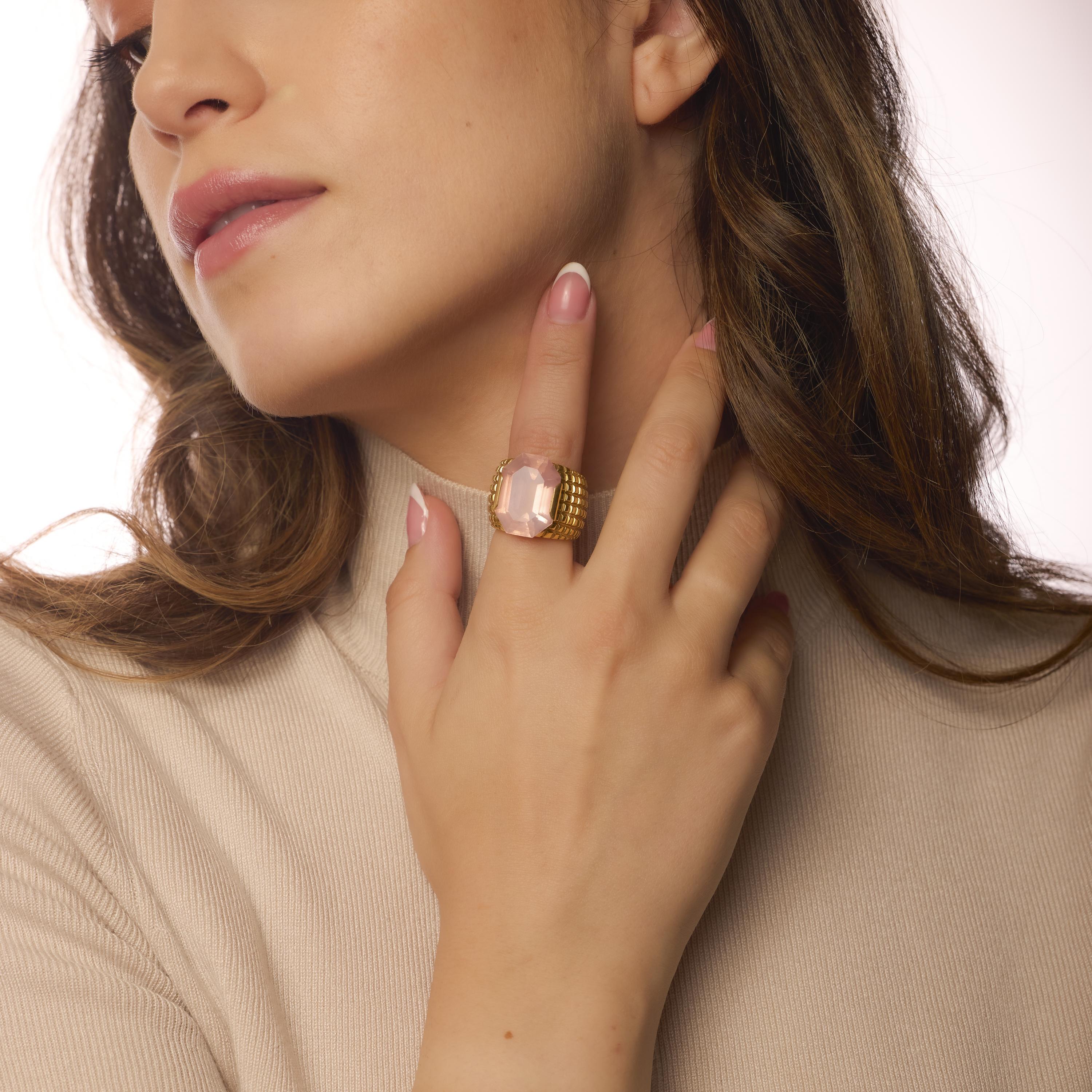 This vintage ring showcases a striking trapezoid pink quartz set in bold 18k yellow gold, offering retro glamour with eye-catching dimension and rich color.