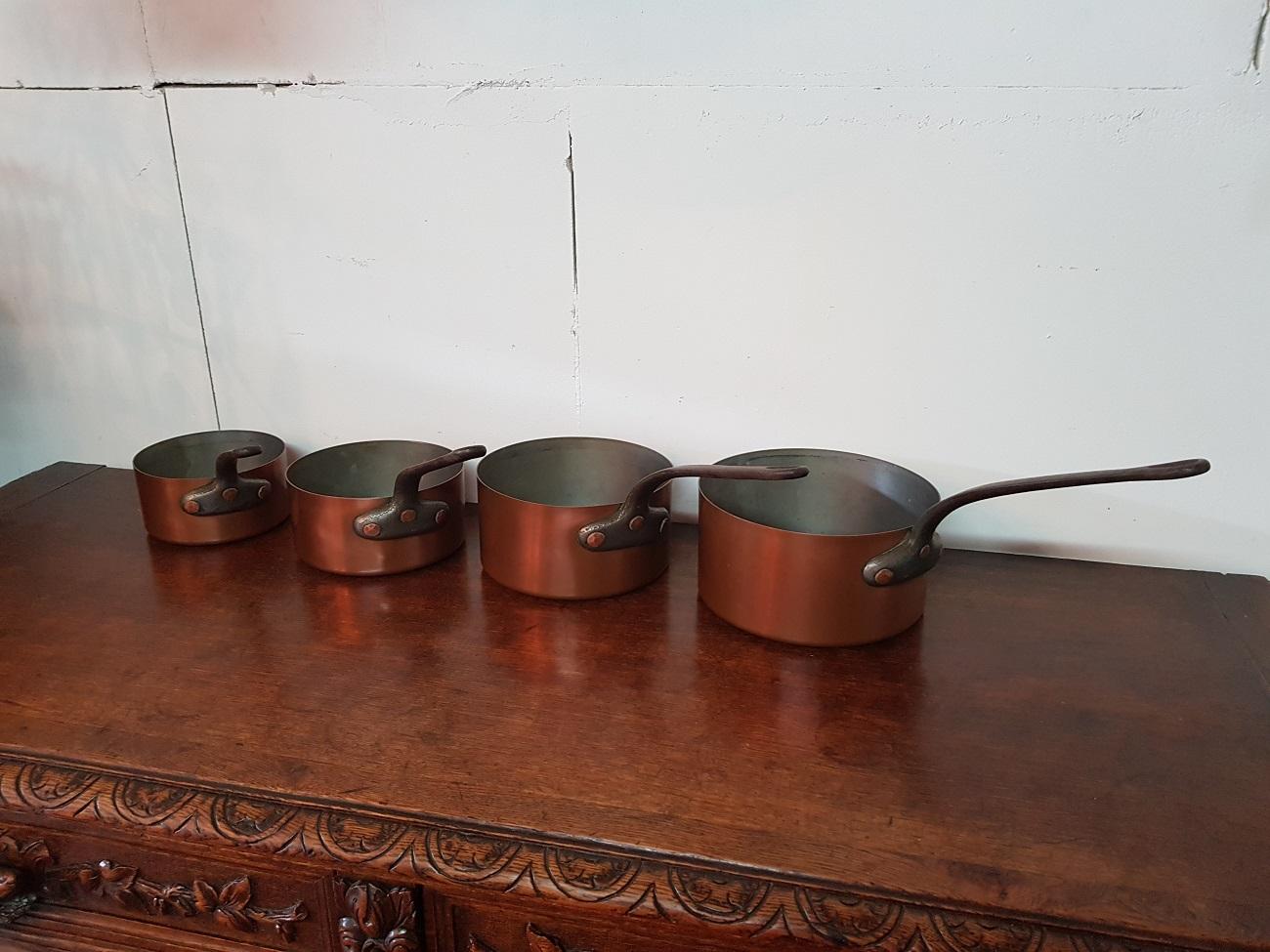 A beautiful and decorative second half of the 20th century 4-piece Vintage French copper cookware set with tinned interior and iron handles.

The measurements are,
Depth 14-20 cm/ 5.5-7.8 inch.
Width 14-20 cm/ 5.5-7.8 inch.
Height 7.5-10.5 cm/