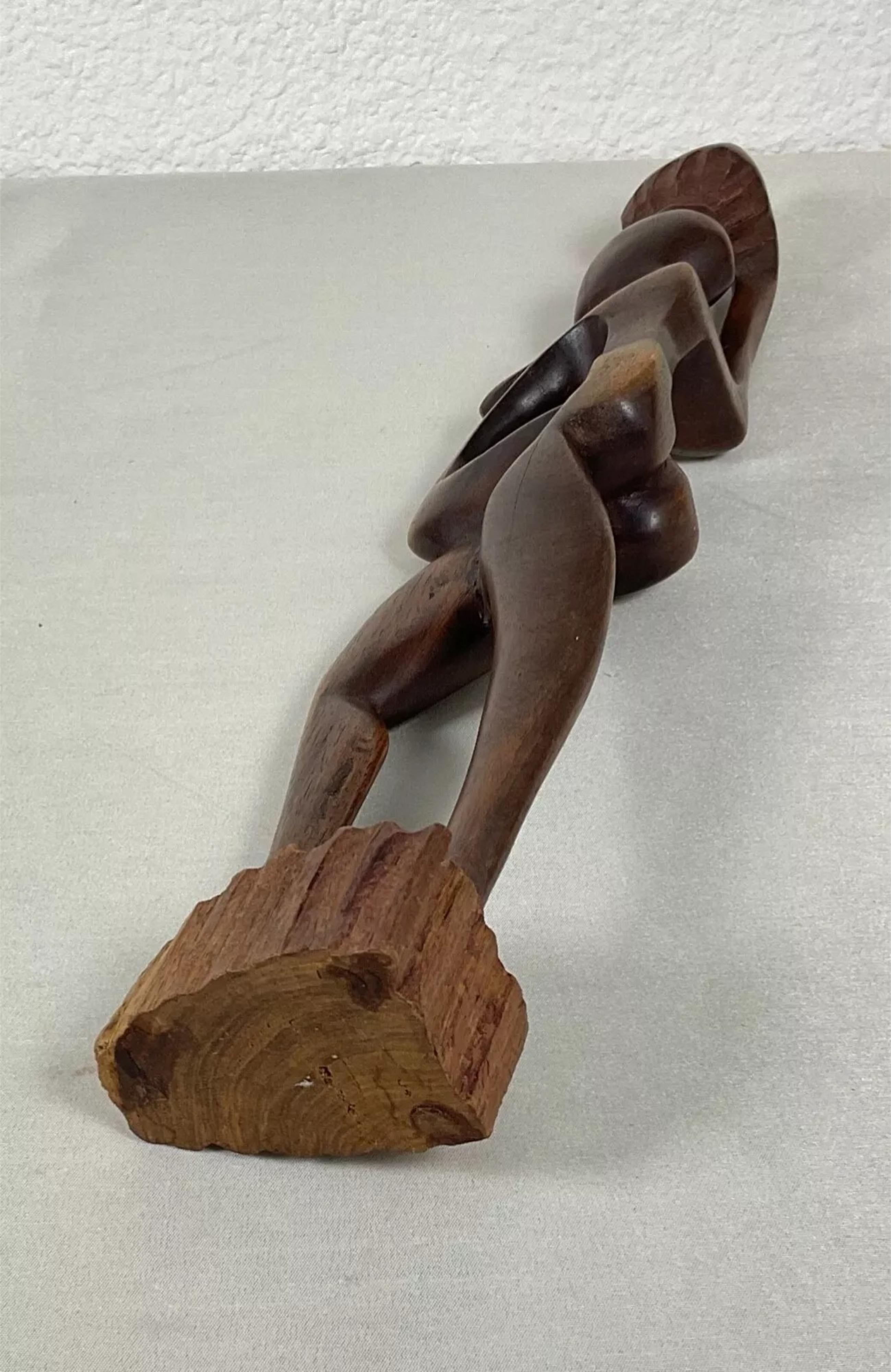 This vintage 20th-century abstract African wooden sculpture is an exquisite example of traditional craftsmanship and artistry. Measuring 20.3 inches (51.5 cm) in height, 2.2 inches (5.5 cm) in length, and 3.3 inches (8.5 cm) in thickness, this piece
