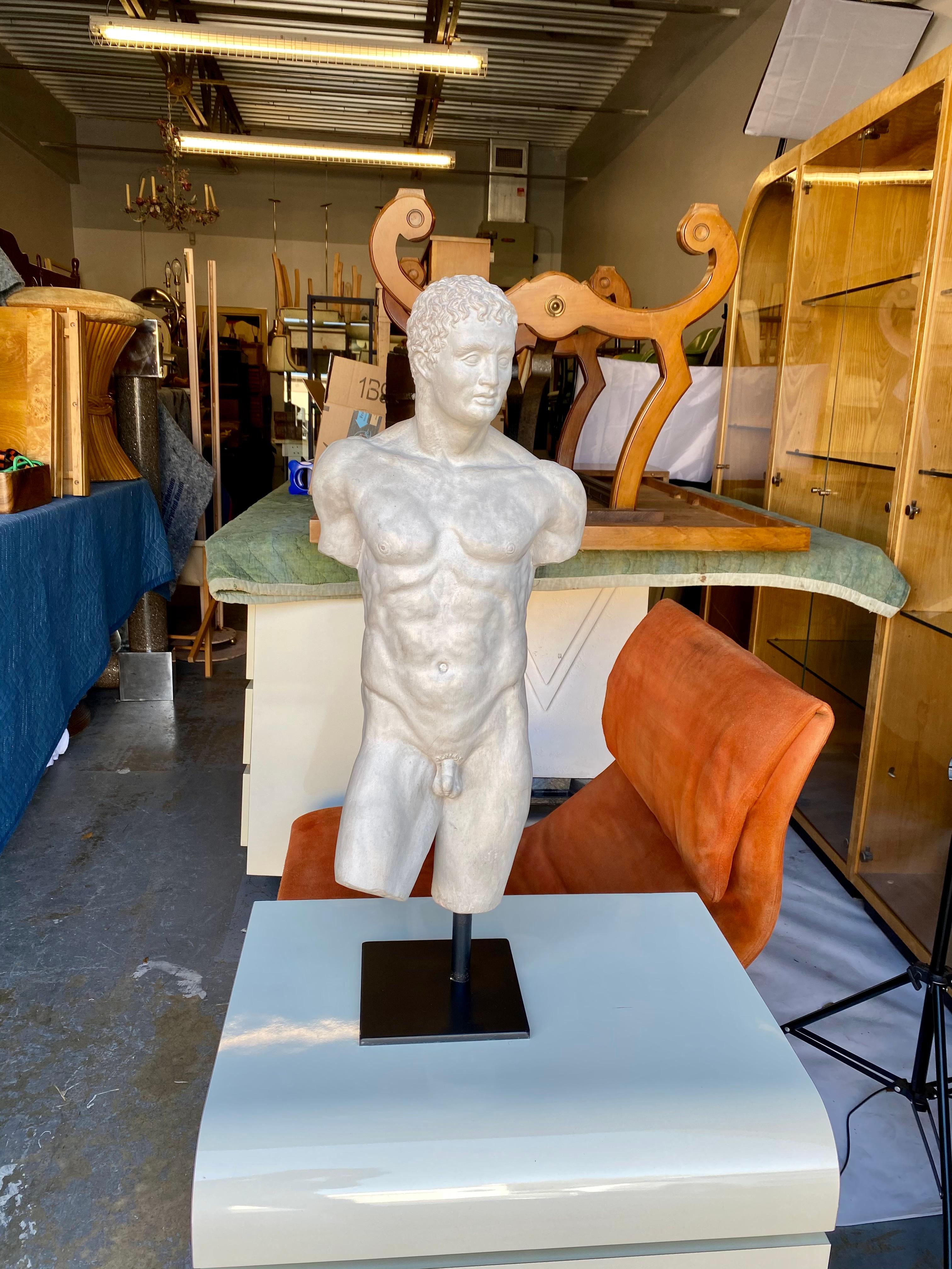 A large room-defining 20th Century half-length figurative nude cast compound sculpture of the Greek God Hermès (Roman God Mercury). An exquisitely rendered male torso and bust mounted on an ebonized steel base. Substantial in both size and