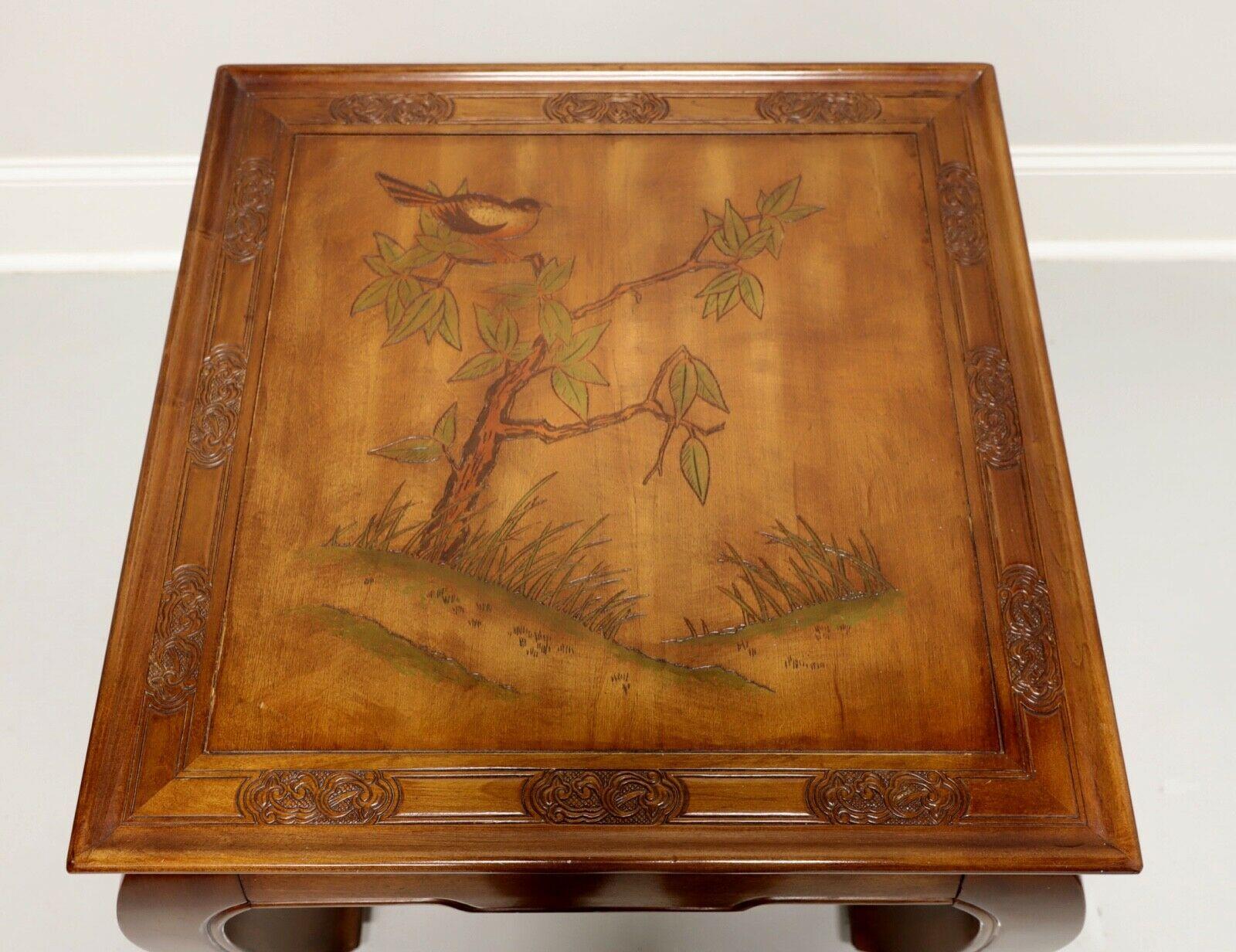An Asian Ming style accent table, unbranded. Solid hardwood with carved Chinoiserie scene to top, Ming style apron and legs. Features top with carved bird in tree and delicate carvings to the banding. Made in USA, in the late 20th