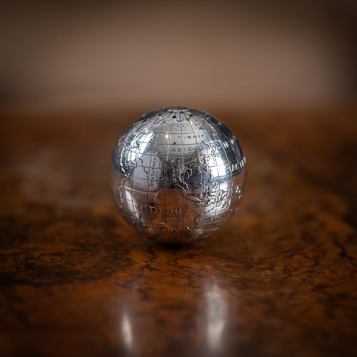 Lijadora inglesa vintage del siglo XX con forma de globo terráqueo, fabricada en plata maciza y con una base lastrada para estabilizarla sobre la mesa del despacho. Hecha a mano con continentes en relieve y aplicados sobre océanos rebajados, también