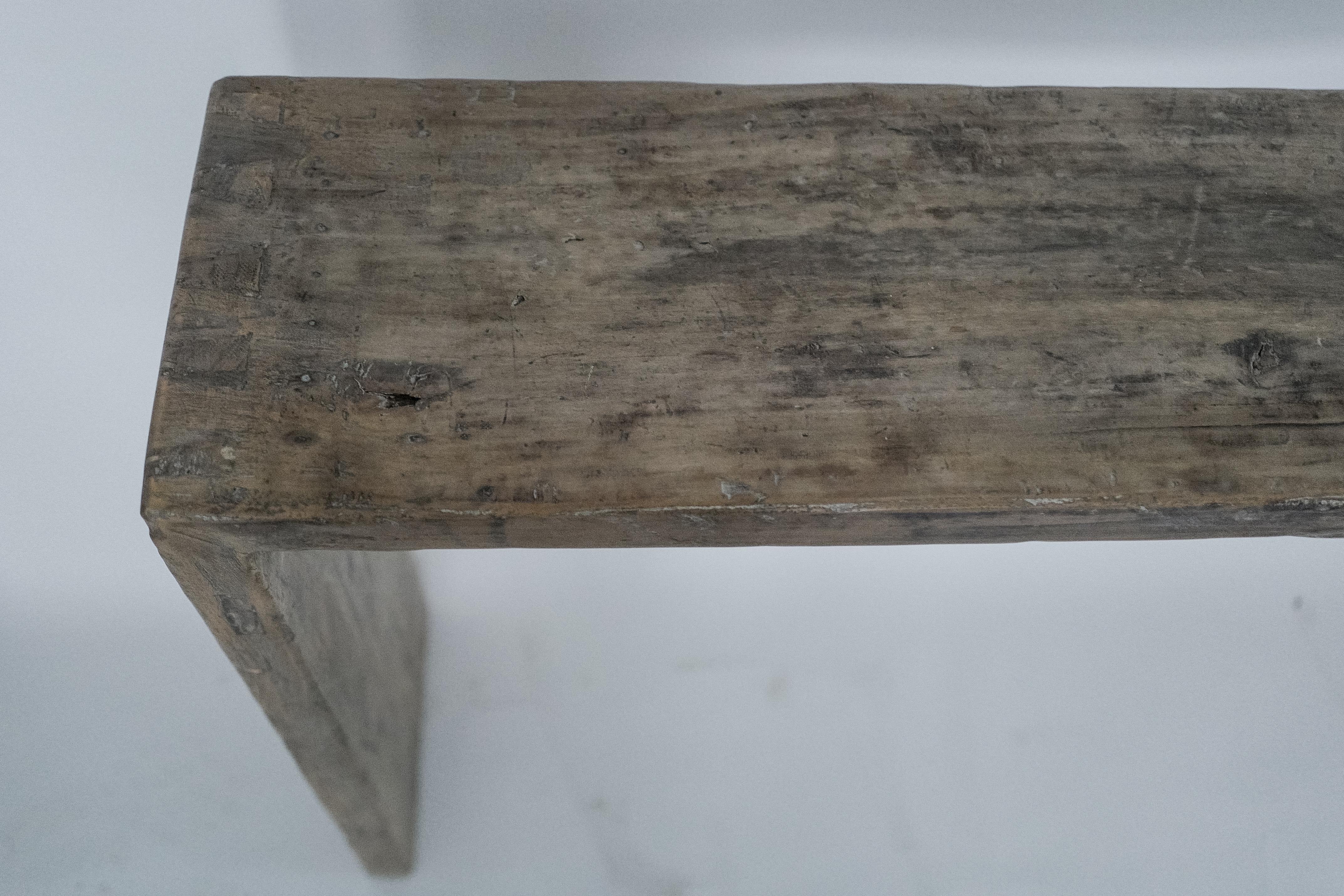 Crafted from solid elm wood, this 20th-century Chinese console table combines traditional Chinese craftsmanship with a minimalist, modernist aesthetic. The light patina enhances the wood’s natural grain, adding subtle character without overpowering