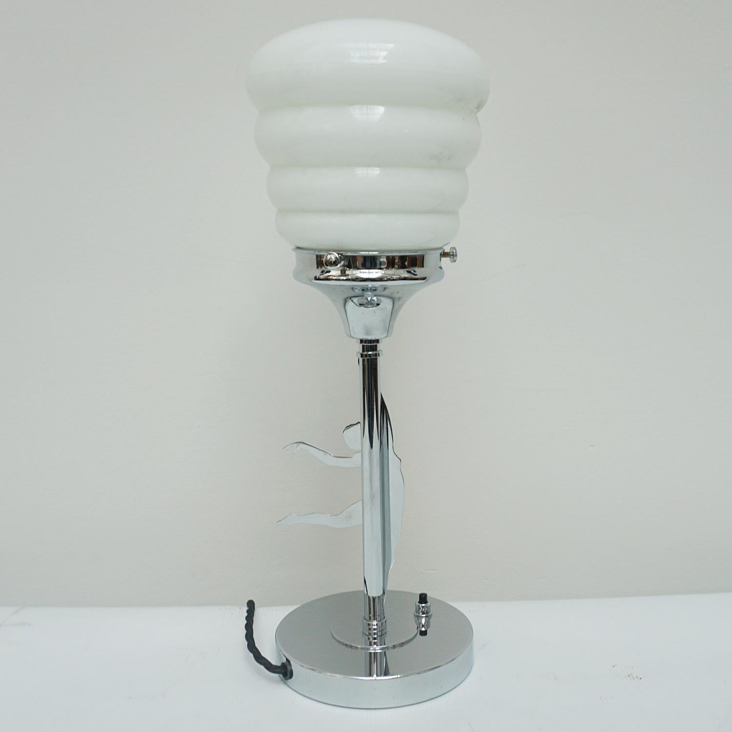 A 20th century chromed metal table lamp with a chromed metal mounted female dancer. Bevelled glass shade. 

Dimensions: H 40cm D 13cm.

Origin: English

Item Number: J244

All of our lighting is fully refurbished, re-wired, and re-chromed