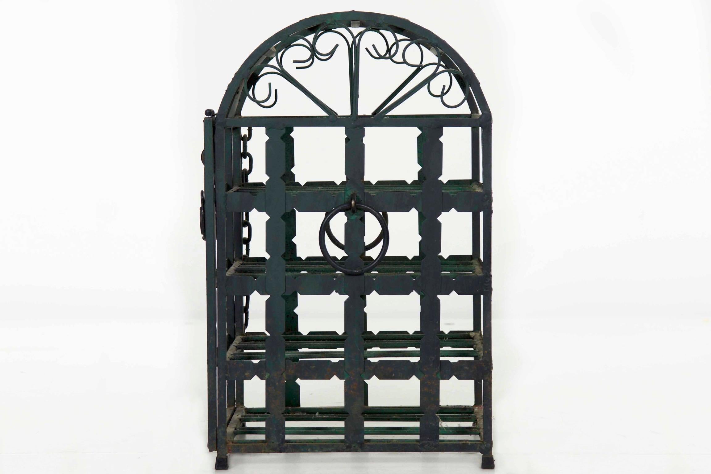 French green painted metal dome top wine cage
For 12 bottles, circa early 20th century


This is a wonderful tabletop dome form wine cage that is suitable for storing twelve bottles. The front drops down while remaining supported with a chain to