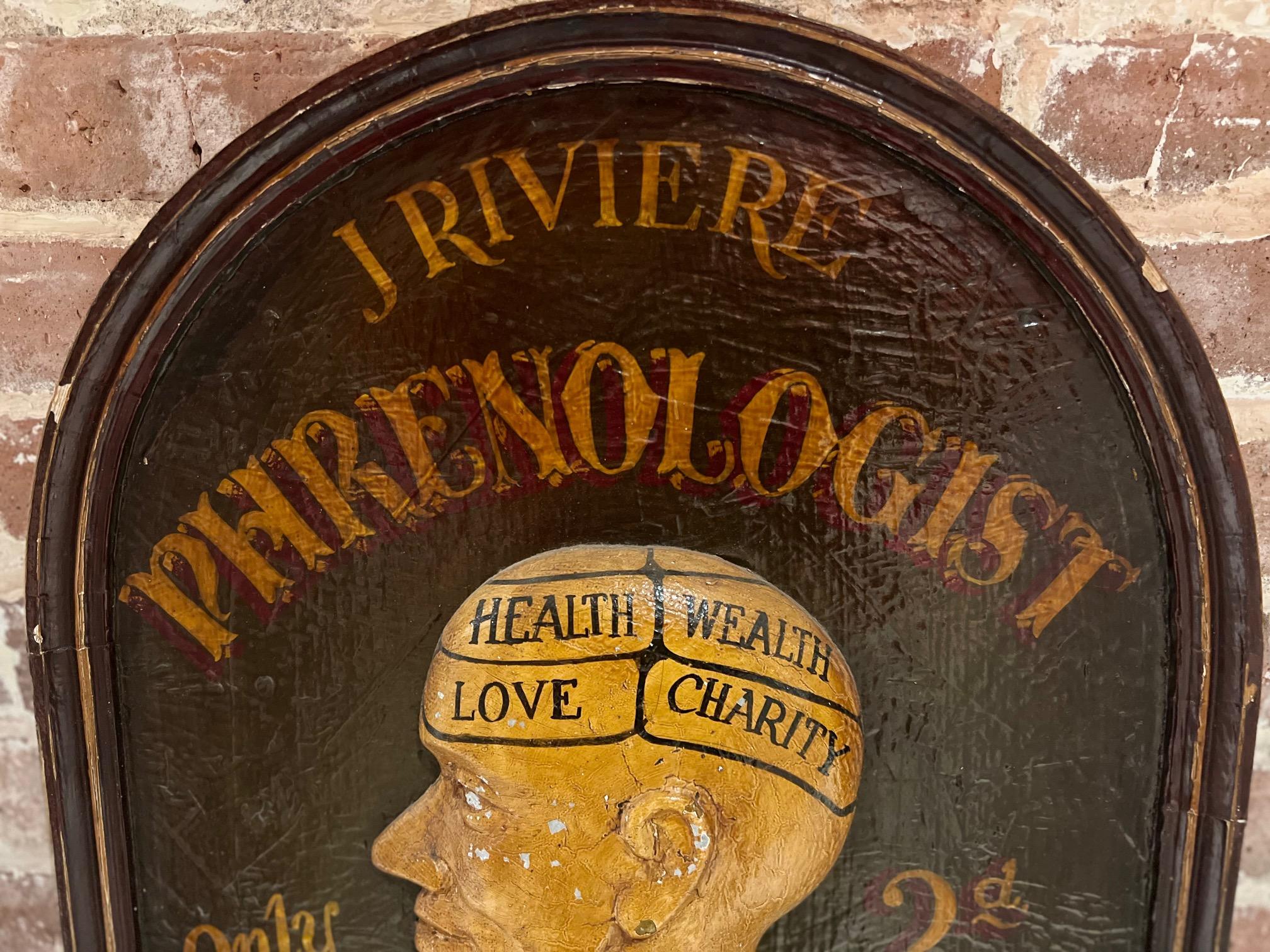 Vintage 20th c., trade sign with plaster side profile of a head on painted wood. The sign, painted in chocolate brown with gold script, reads 