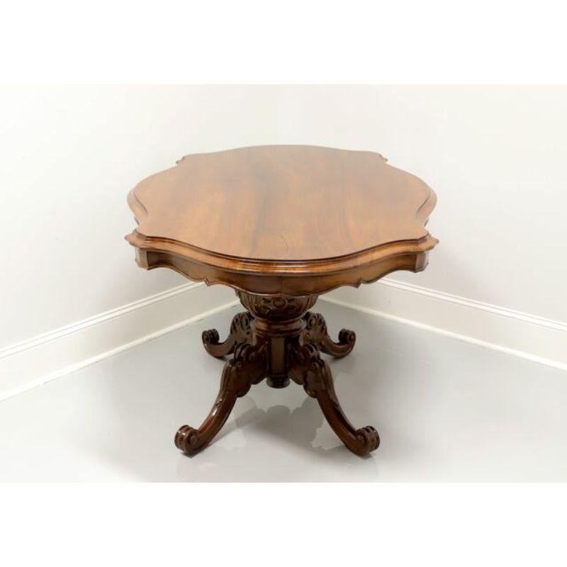 A serpentine oval dining table in the Italian Baroque style, unbranded. Solid walnut with single pedestal base and four scroll feet. Features a serpentine oval top, carved apron, ornately carved center pedestal with acanthus leaves, carved knees and