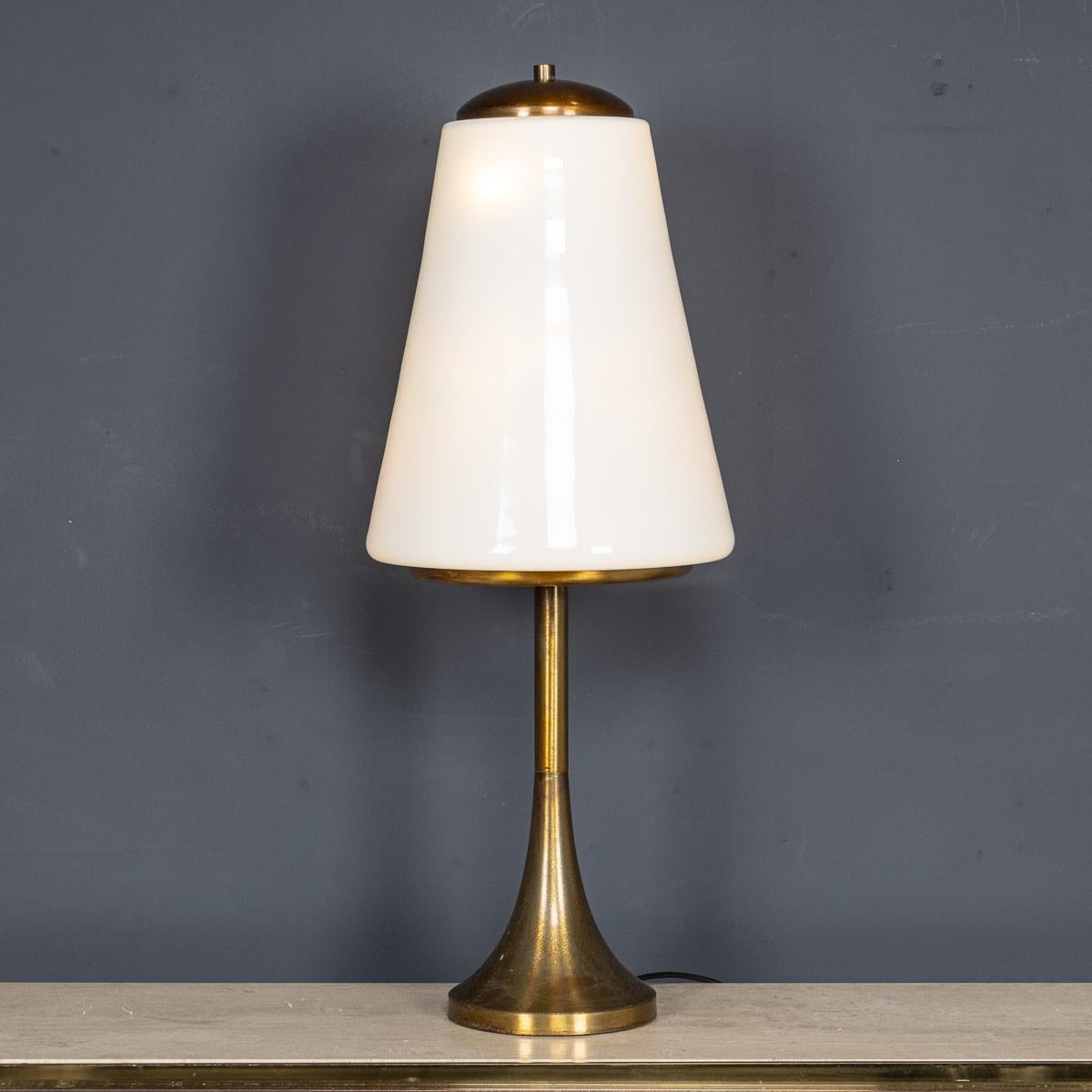 A Vintage 20th Century lamp crafted in Italy, featuring brass accents and white opaque glass, dating back to the 1970s. The shade accommodates six bulbs illuminating any space with grace. A testament to the elegance of Italian design, this lamp