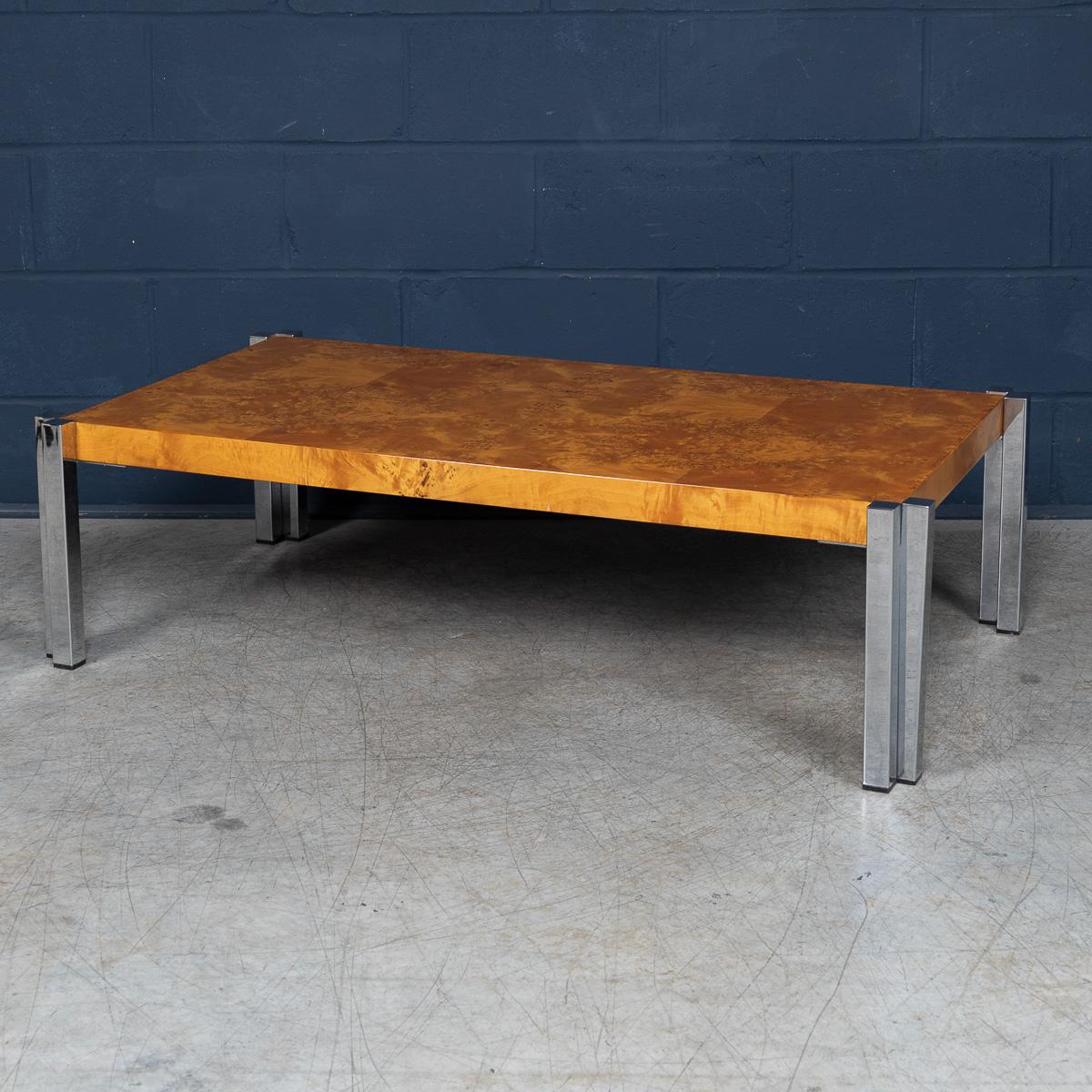 This striking Italian coffee table from circa 1980 combines luxurious burr walnut with gleaming chrome for a distinctly modern look. The table’s top showcases the rich, swirling grain of burr walnut, its warm tones and natural patterns enhanced by a