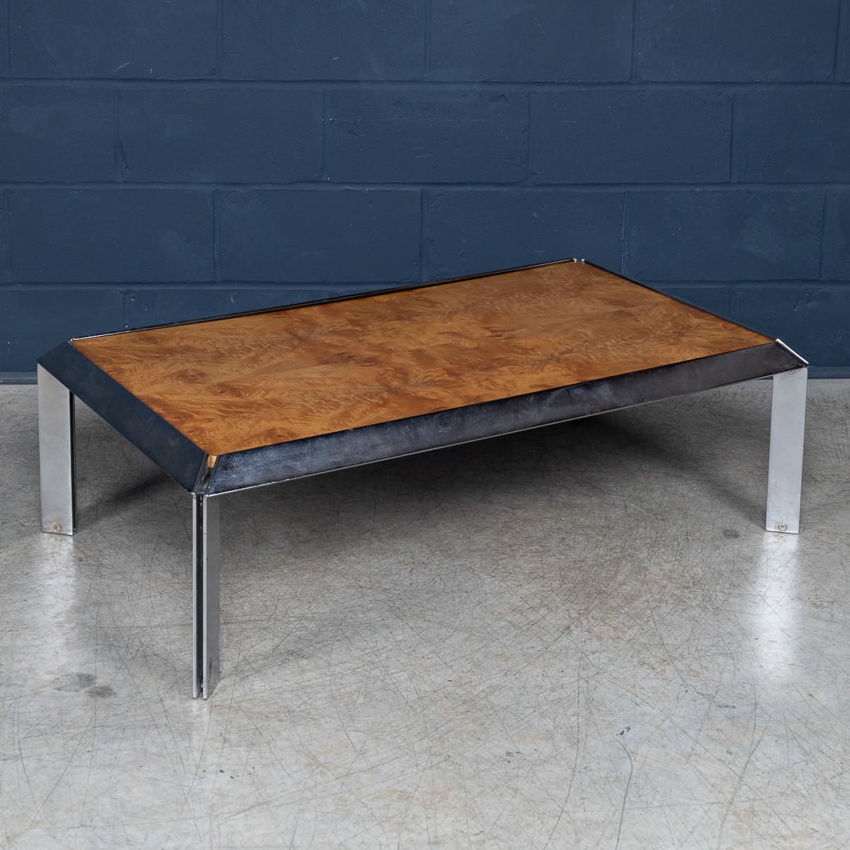 This striking Italian coffee table from circa 1980 combines luxurious burr walnut with gleaming chrome for a distinctly modern look. The table’s top showcases the rich, swirling grain of burr walnut, its warm tones and natural patterns enhanced by a