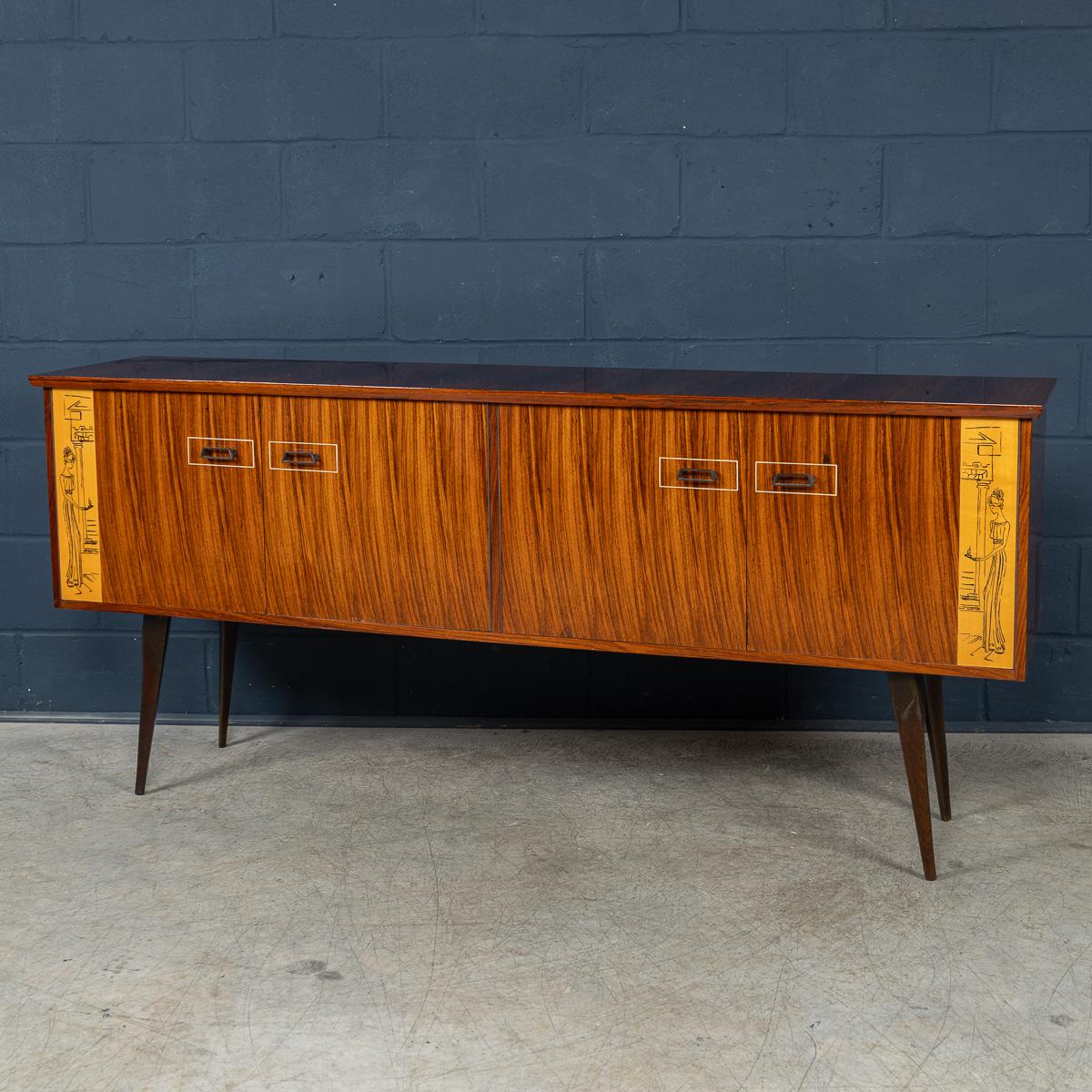 This exceptionally elegant Italian sideboard, manufactured in the 1960s, marries Art Deco flair with Mid-Century Modern sensibilities. Crafted in richly figured veneer wood, its façade is flanked by two neoclassical figures finely drawn into the