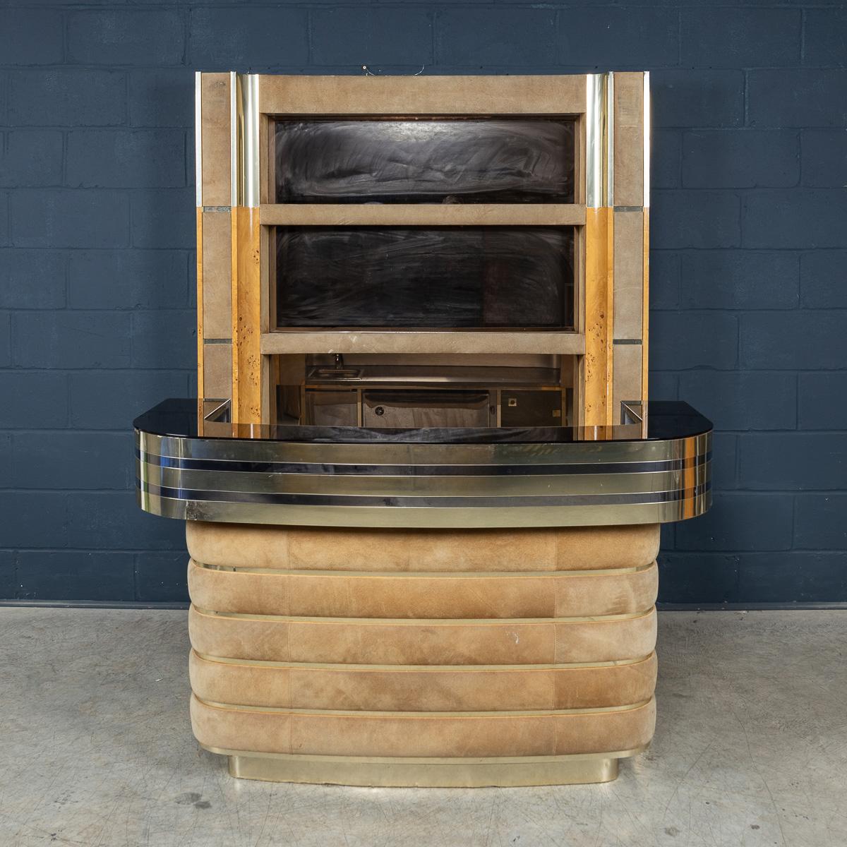 A stunning vintage wet bar finished in alcantara leather, steel, and burr walnut, designed and engineered by Willy Rizzo in the 1970s. Among the most iconic and glamorous creations in Rizzo’s design portfolio, his bars have become highly sought