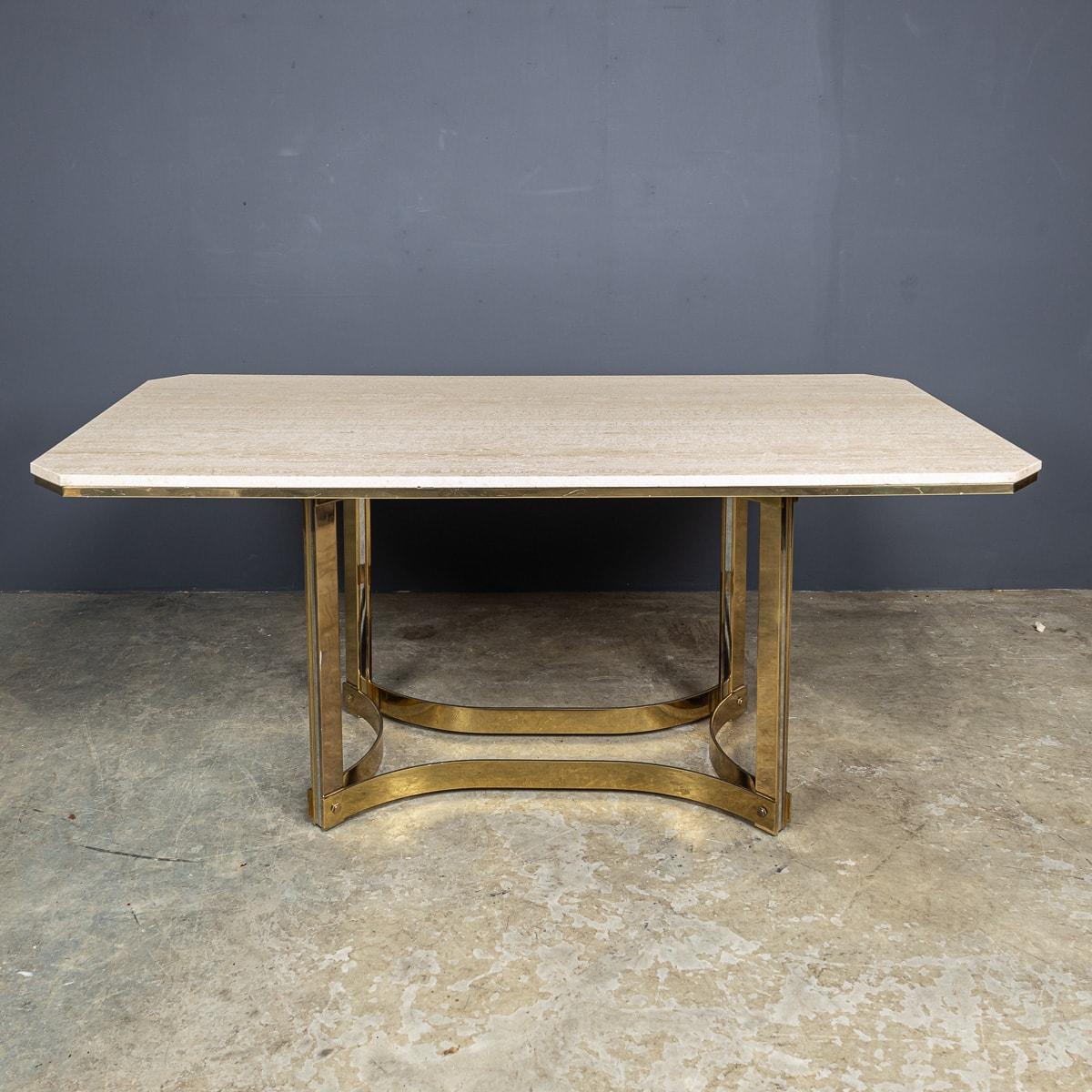 A vintage mid-20th Century dining table envisioned by the renowned designer Alessandro Albrizzi. Crafted in a grand elongated octagonal shape from travertine, it boasts a luxurious gold-plated border and base, adding a touch of opulence to any