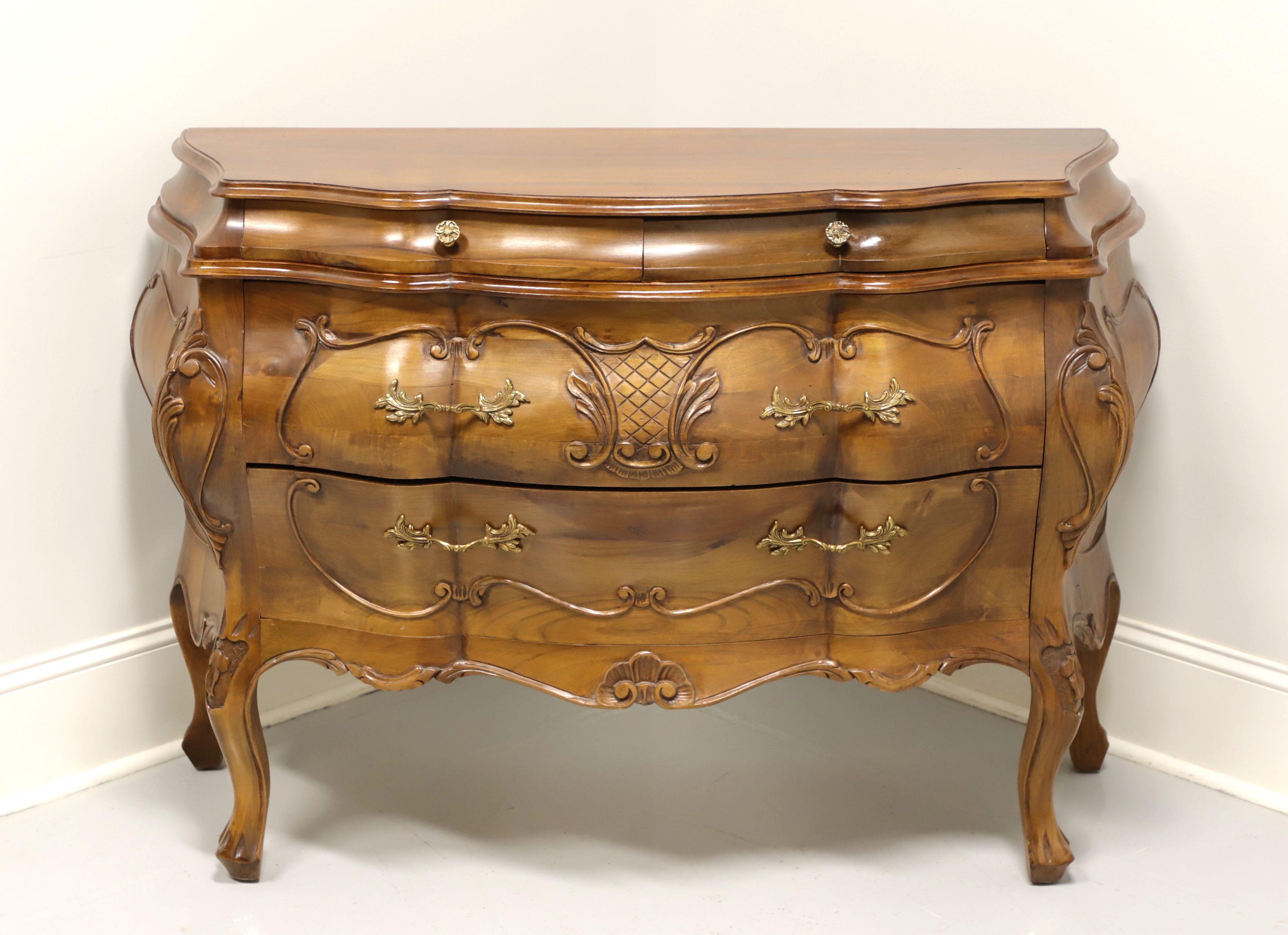 A high quality Italian bombe chest, no makers mark. Walnut with exquisite carvings to draw fronts, sides & knees, carved curved legs and paw like feet. Features two smaller over two larger drawers with brass hardware. Made in Italy, in the late 20th