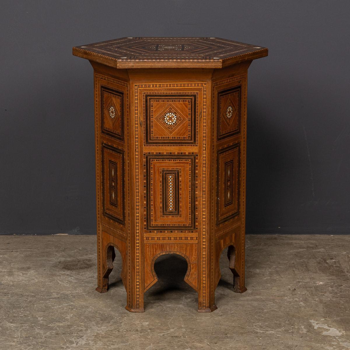 An exquisite 20th-century Levantine side table, masterfully crafted from bone, mother of pearl, various wood hues, and ebonised wood. This stunning piece of art showcases meticulous craftsmanship, with each precisely sized component reflecting hours