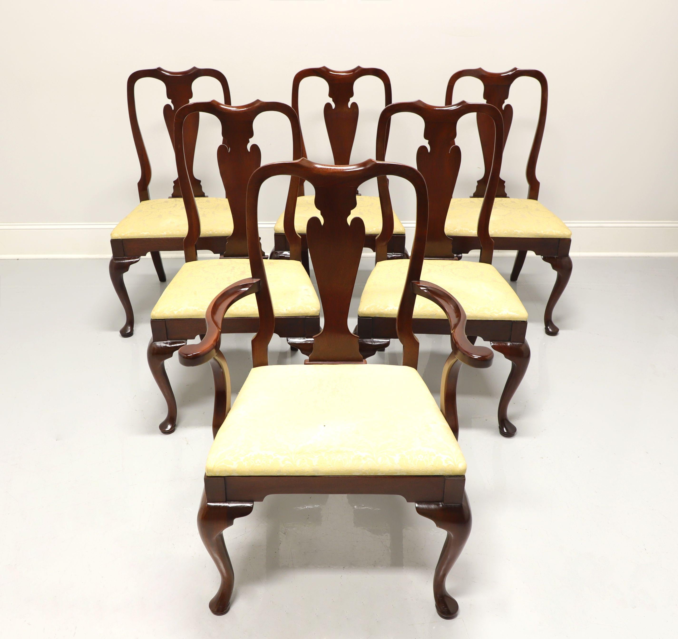 A set of six Queen Anne style dining chairs by Hickory Chair. Mahogany with solid carved backs, cabriole legs, pad feet and creamy yellow fabric upholstered seats. Five side chairs and one armchair. Made in the USA, in the late 20th