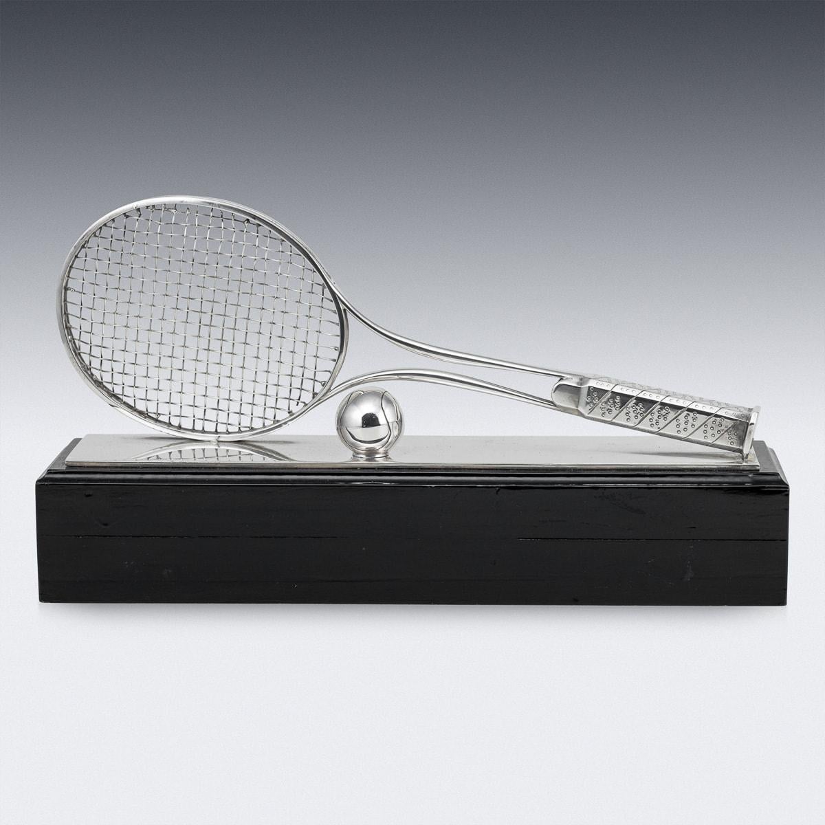 Vintage 20th Century pair of English silver plated tennis trophies. Designed as a racquet and ball on top of an ebonised wooden stand, this pair of trophies would be a great winning prize for a doubles team or for a display case.

CONDITION
In Great